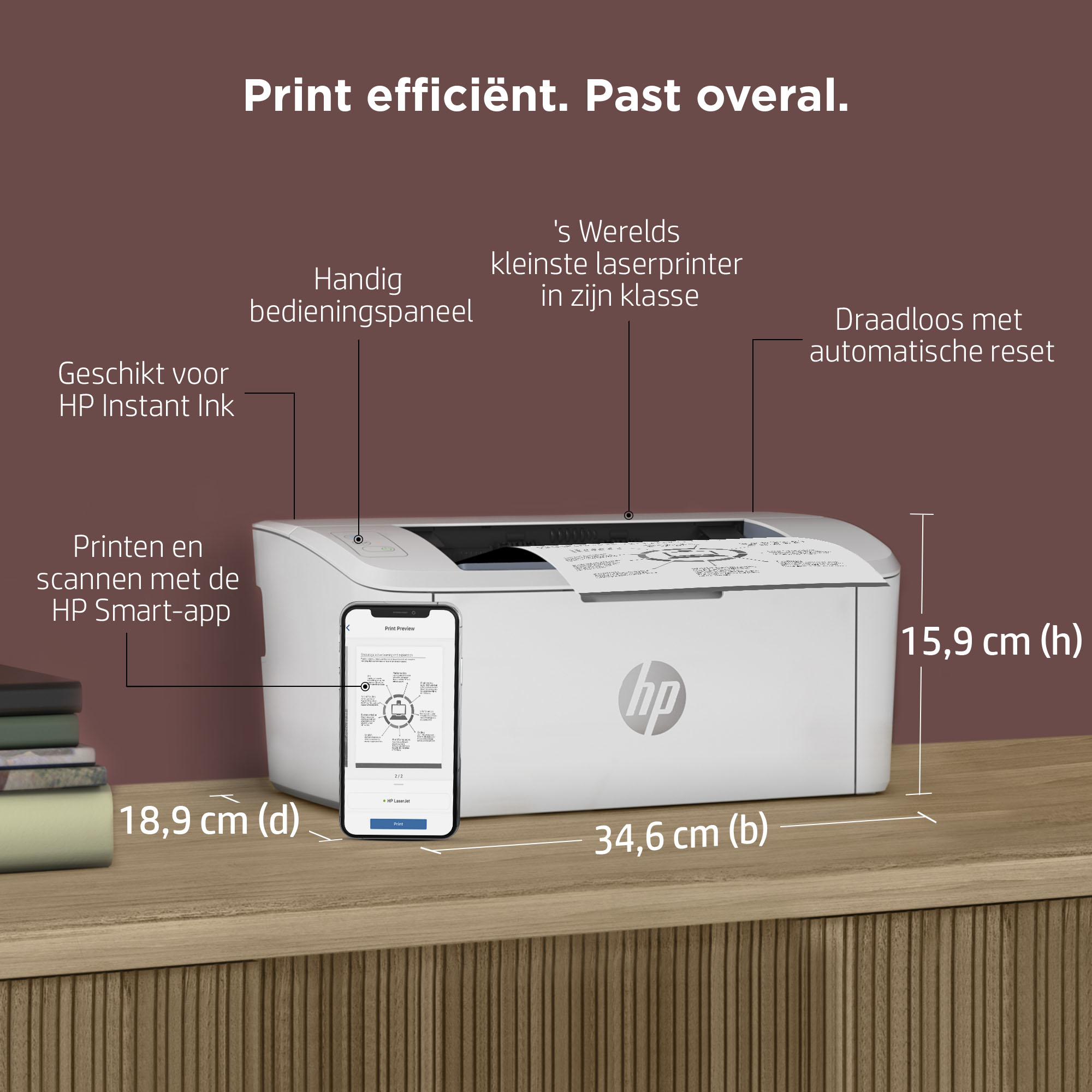 A white HP printer with a phone next to it on a wooden table.