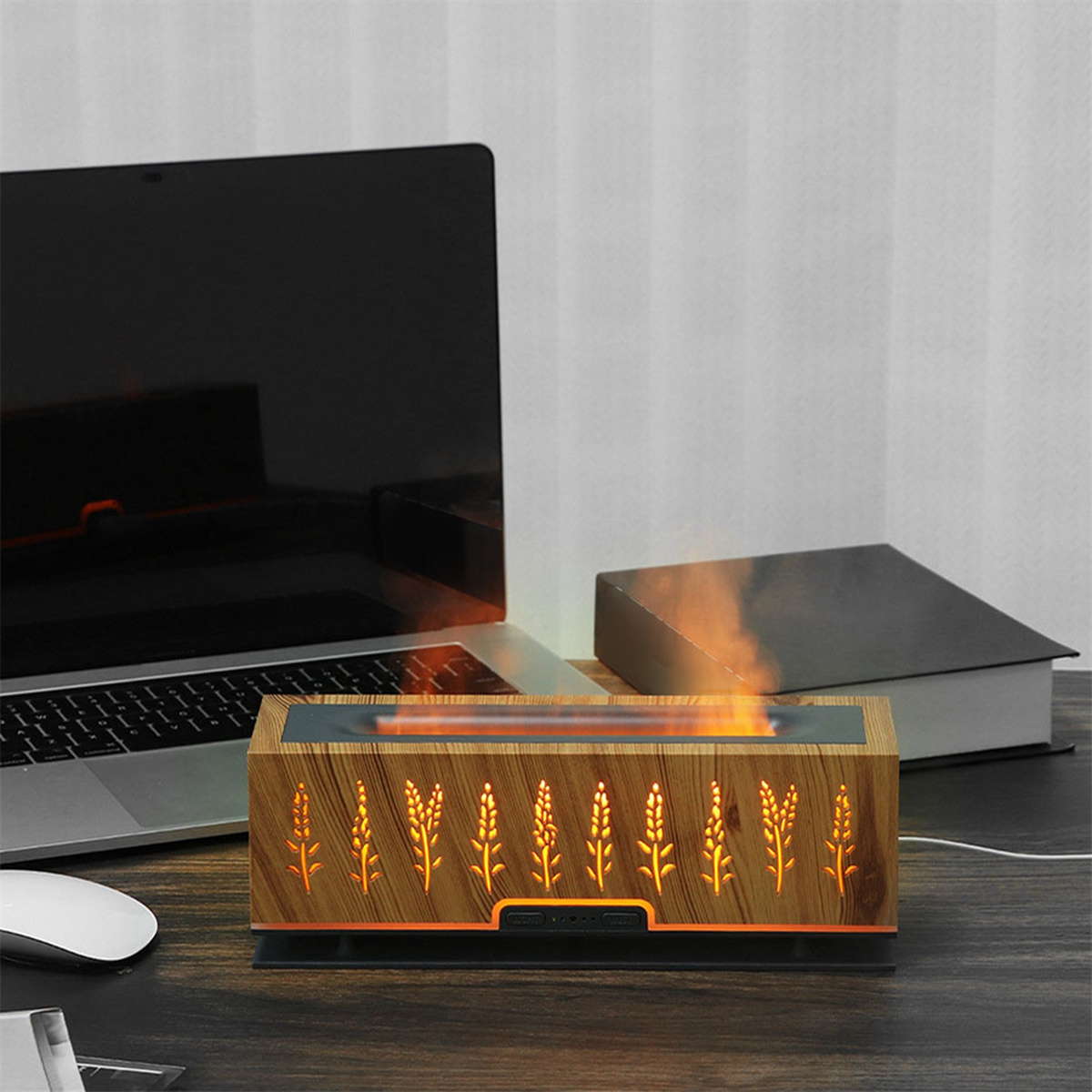 Aroma-Diffusor aus Holz mit Laptop und Buch. Der Diffusor hat beleuchtete Weizenähren-Designs.