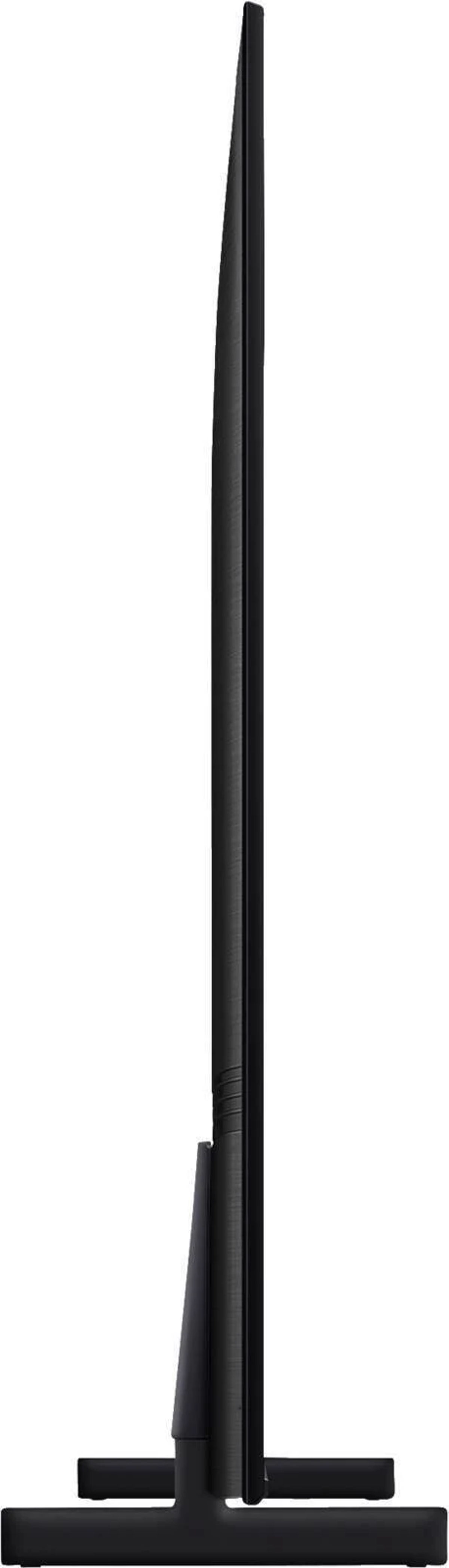 Widok z boku czarnego telewizora ze stojakiem na białym tle.
