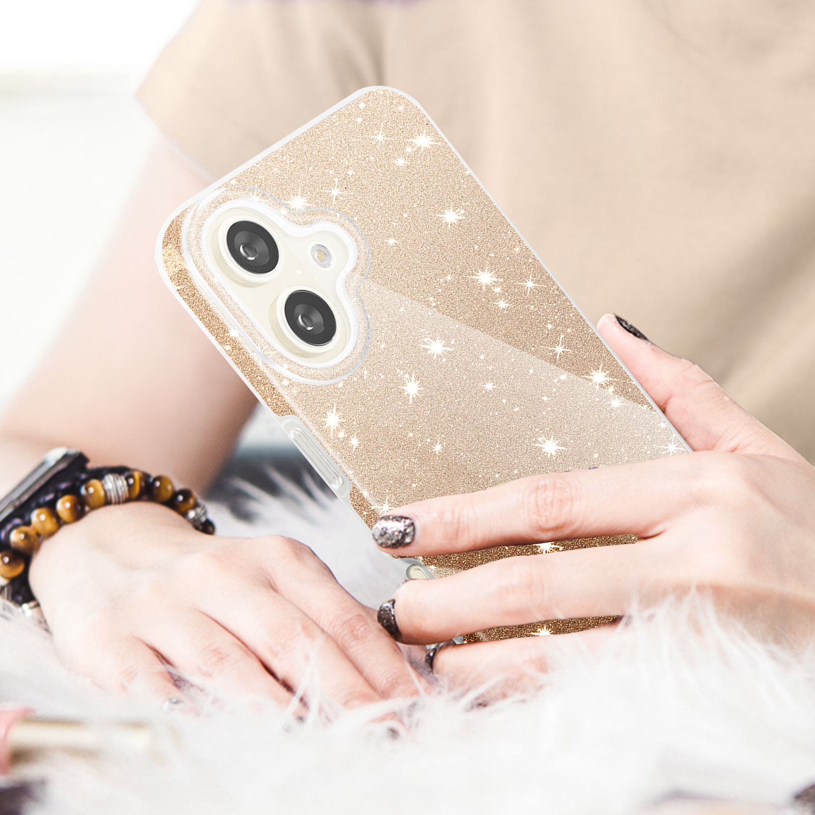 Eine Handyhülle mit glitzerndem Golddesign, gehalten in einer Hand.