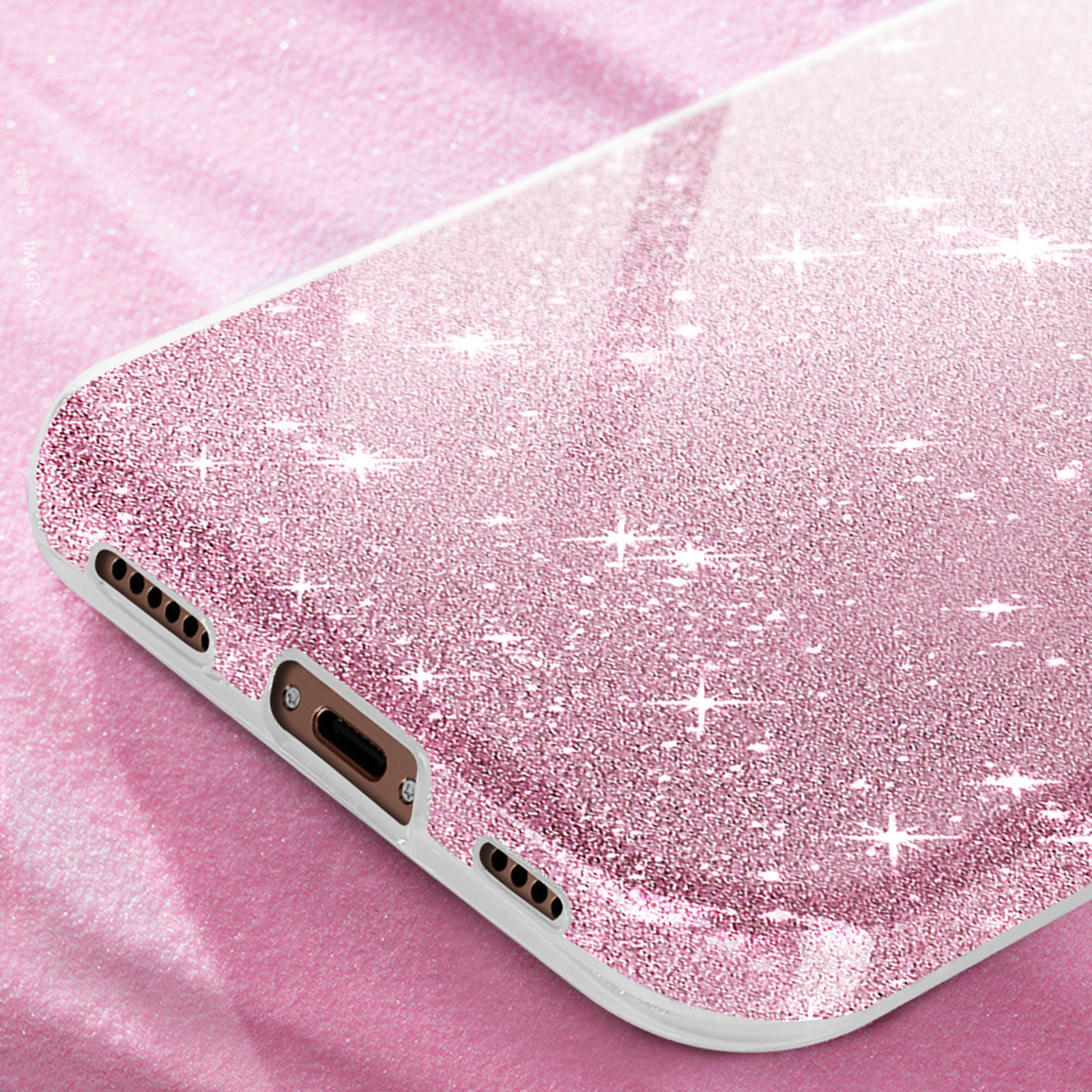 Custodia rosa per telefono con glitter, su sfondo rosa, primo piano.