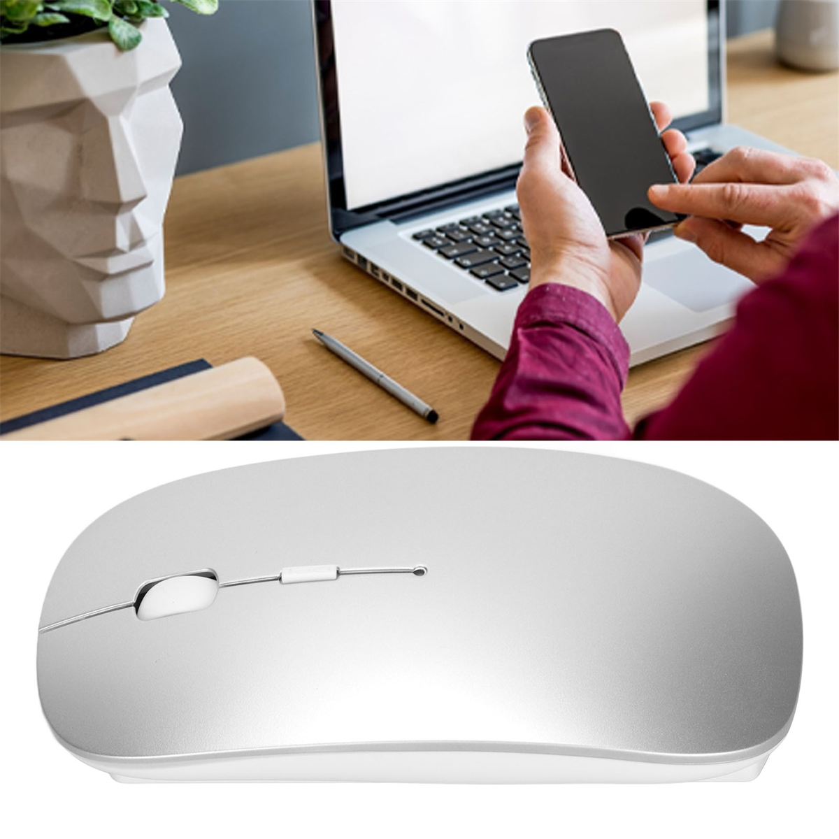 Eine Person benutzt ein Telefon und einen Laptop. Eine silberne Maus im Vordergrund. Der Hintergrund ist ein Schreibtisch.