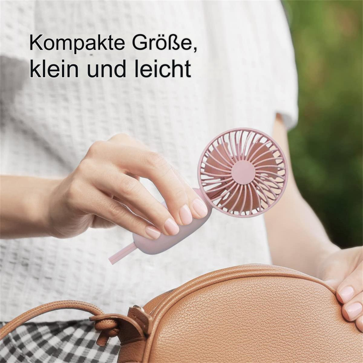 Eine Frau hält einen kleinen rosa Ventilator, im Hintergrund eine braune Handtasche.