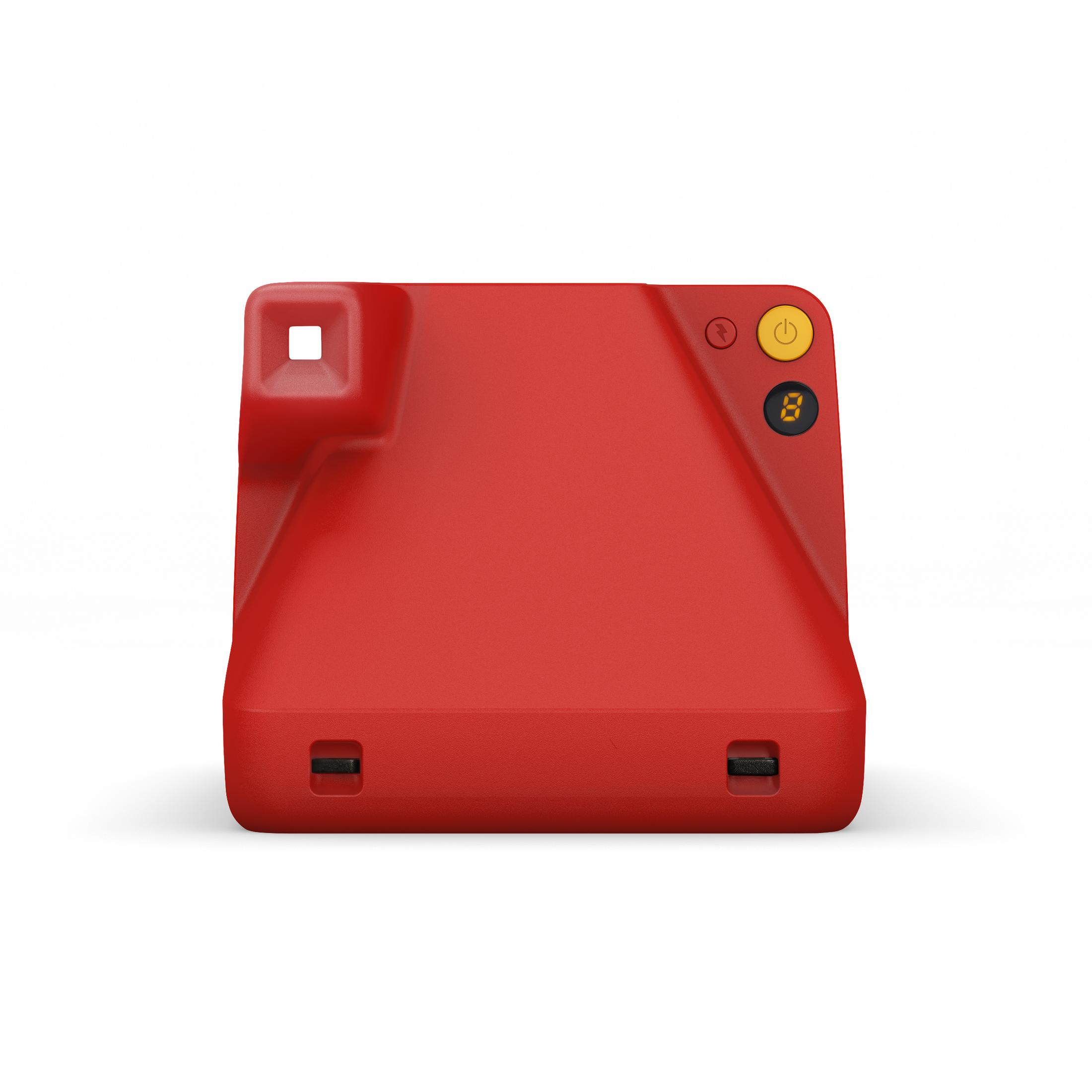 Czerwony aparat natychmiastowy z przyciskami zasilania i lampy błyskowej. Kwadratowy kształt.