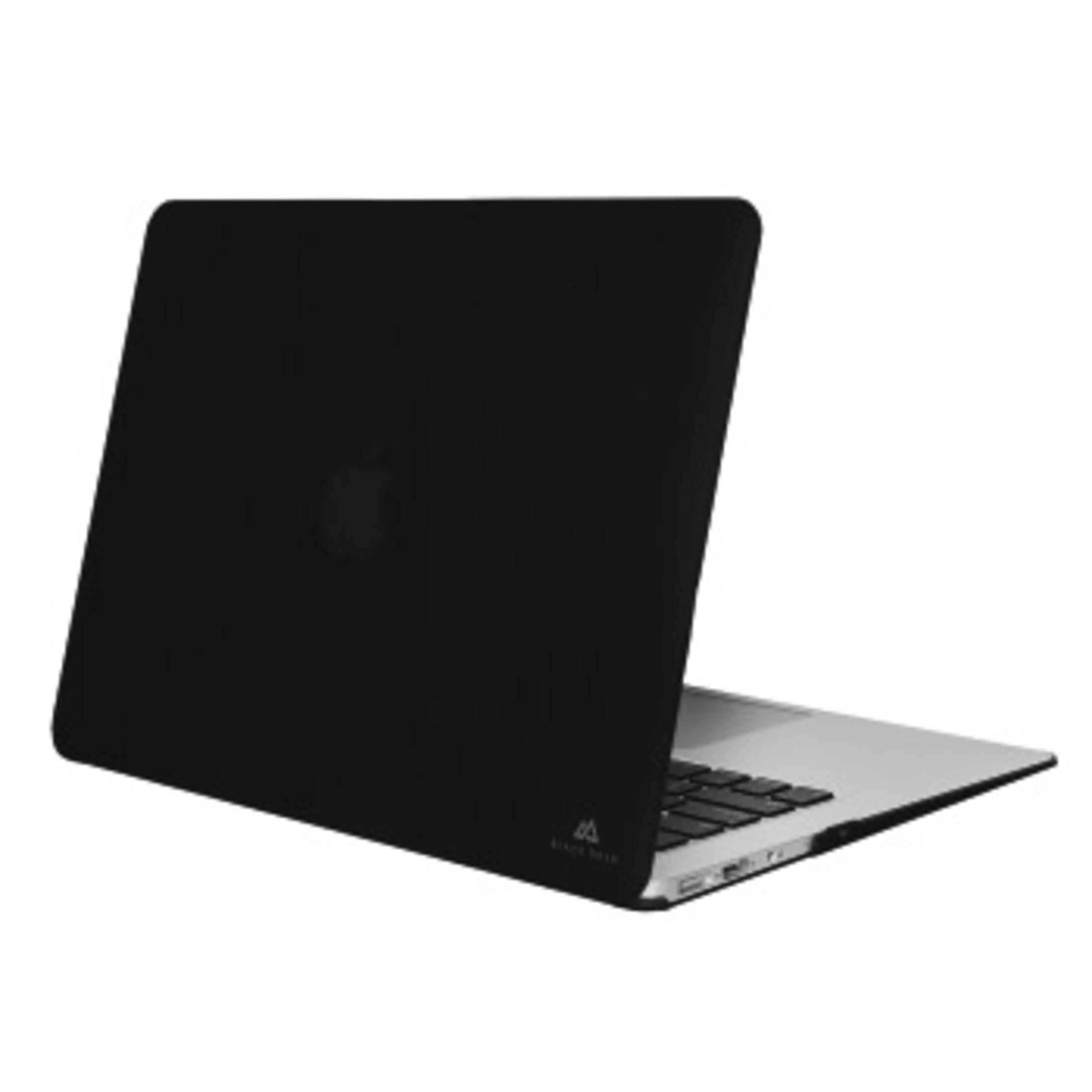 Un laptop nero con il logo Apple sul retro, chiuso su un tavolo.