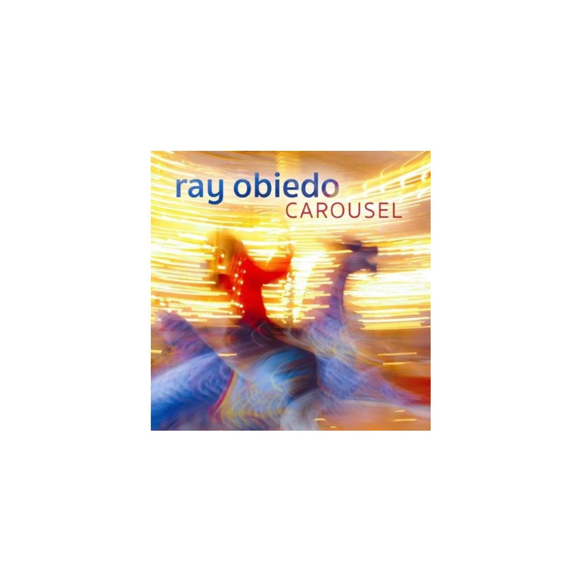 Pochette d'album : Personne sur un cheval de manège. Titre : Carousel. Artiste : Ray Obiedo.