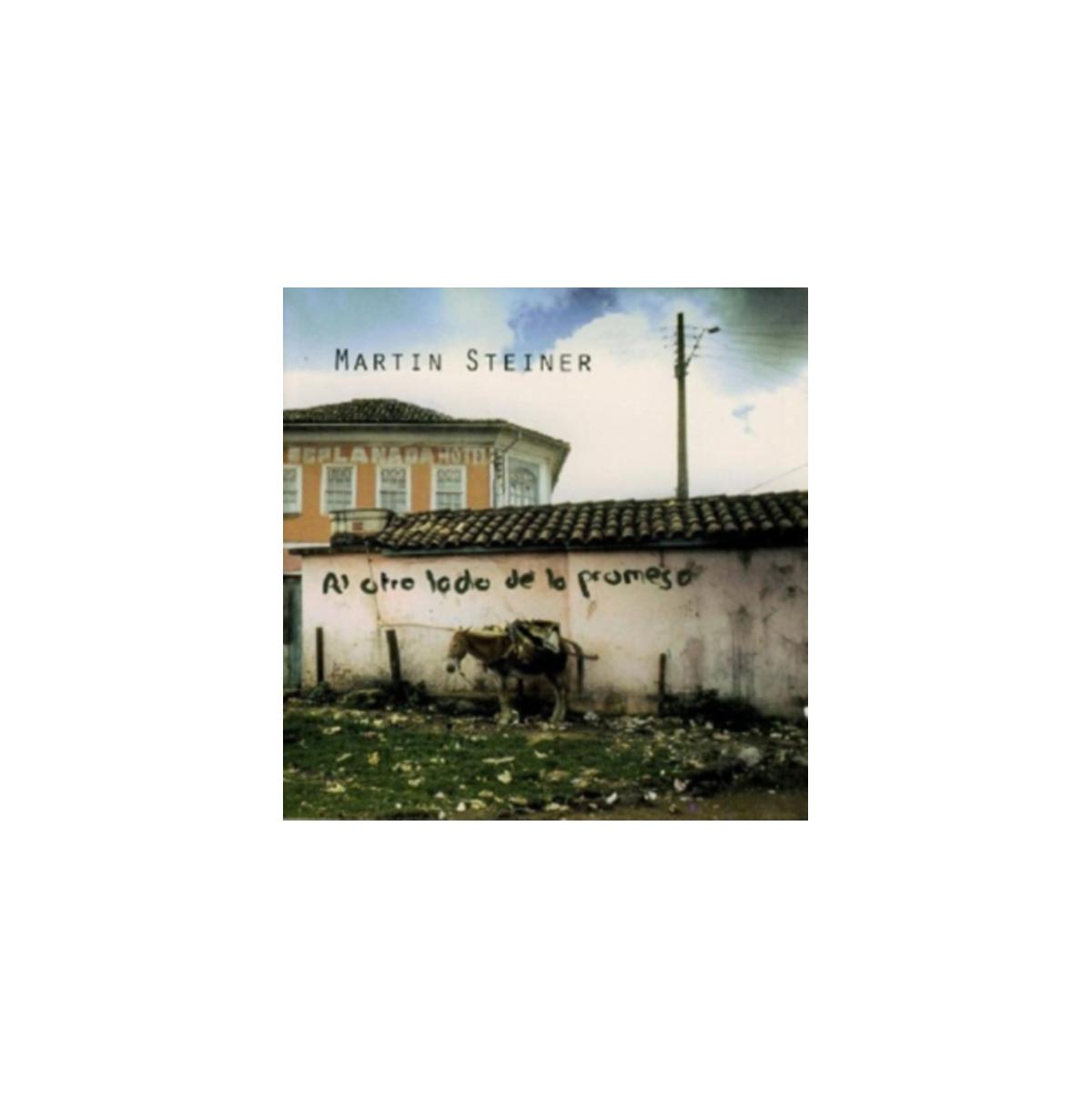 Pochette d'album : un âne près d'un mur avec des graffitis en espagnol. Une maison et des lignes électriques en arrière-plan.