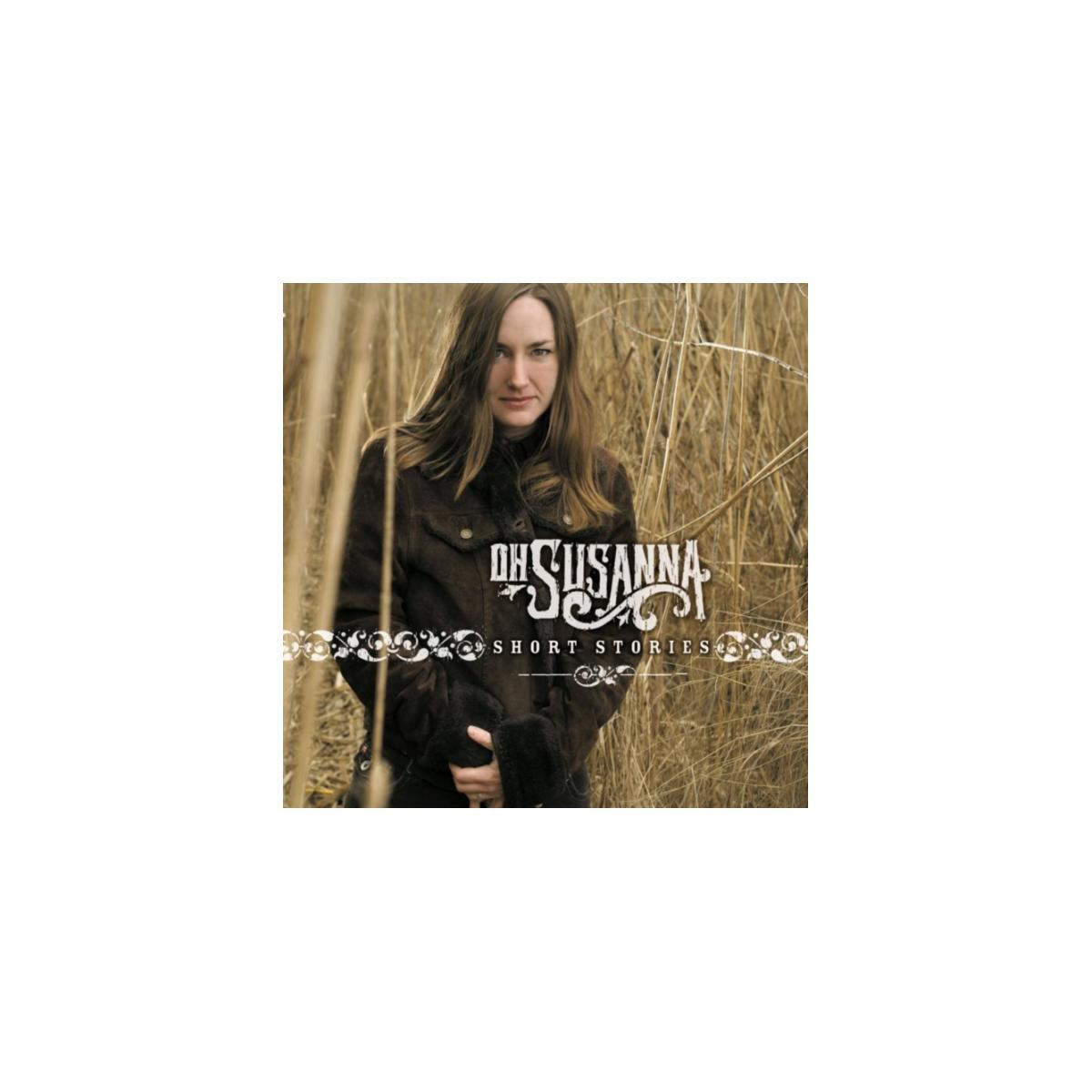 Albumhoes van 'Short Stories' van Oh Susanna. Vrouw in jas staat in veld. Lang gras achter haar.