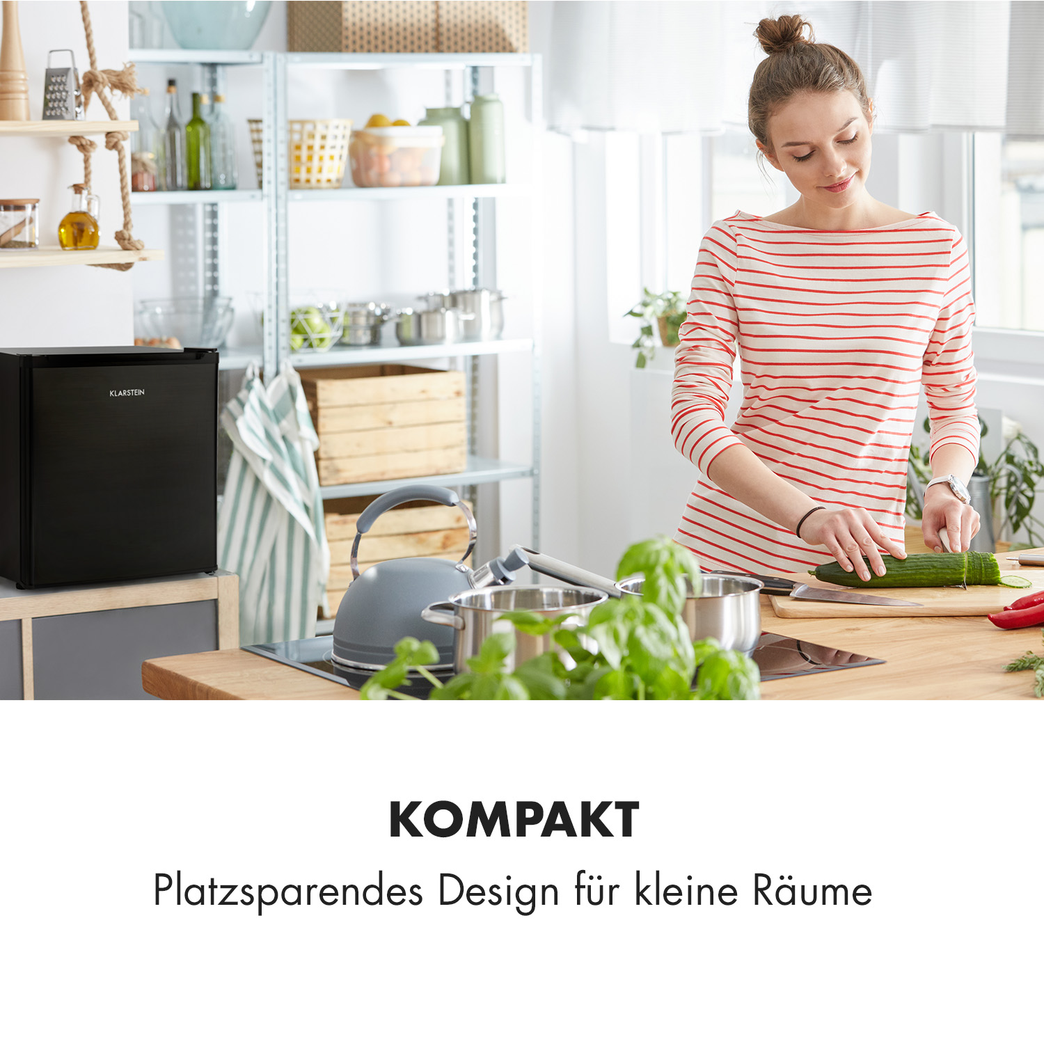 Eine Frau in einem gestreiften Hemd bereitet Essen in einer Küche mit einem kleinen schwarzen Kühlschrank zu.
