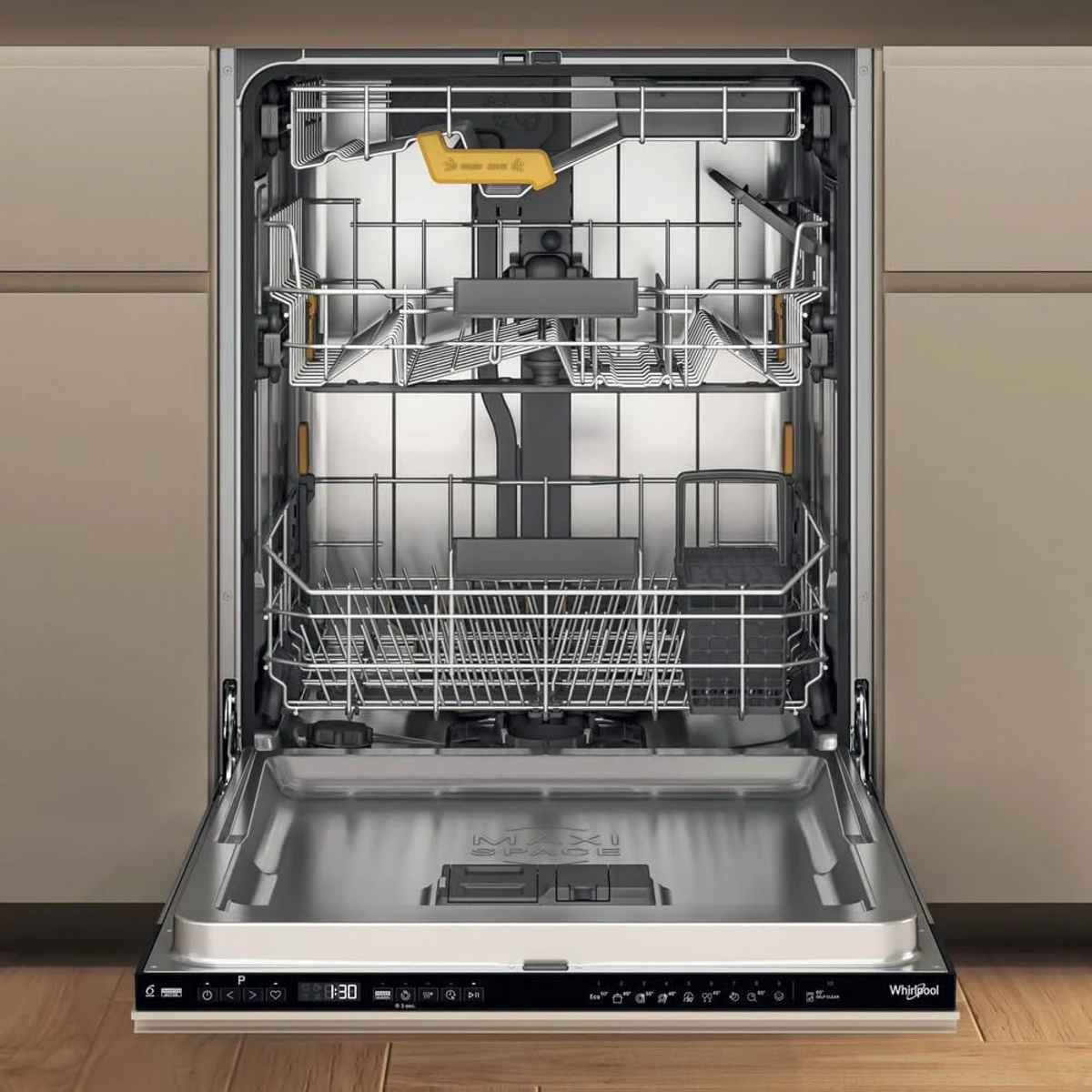 Open dishwasher with racks visible, on wooden floor, beige cabinet background.