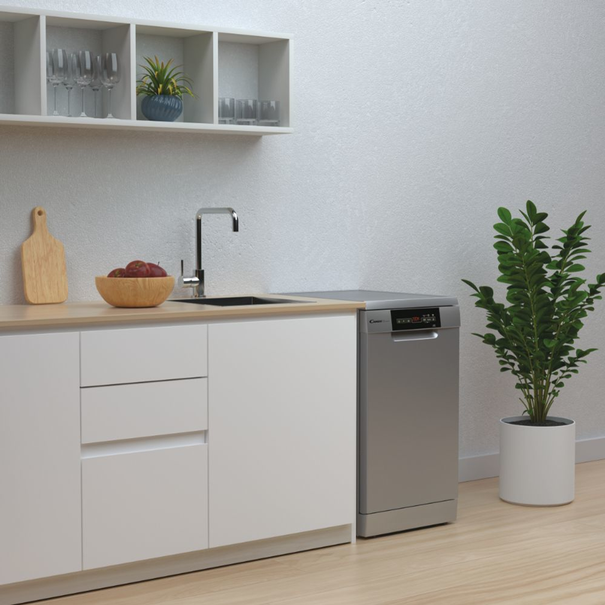 Escena de cocina con lavavajillas, encimera con un cuenco de manzanas y una planta alta.