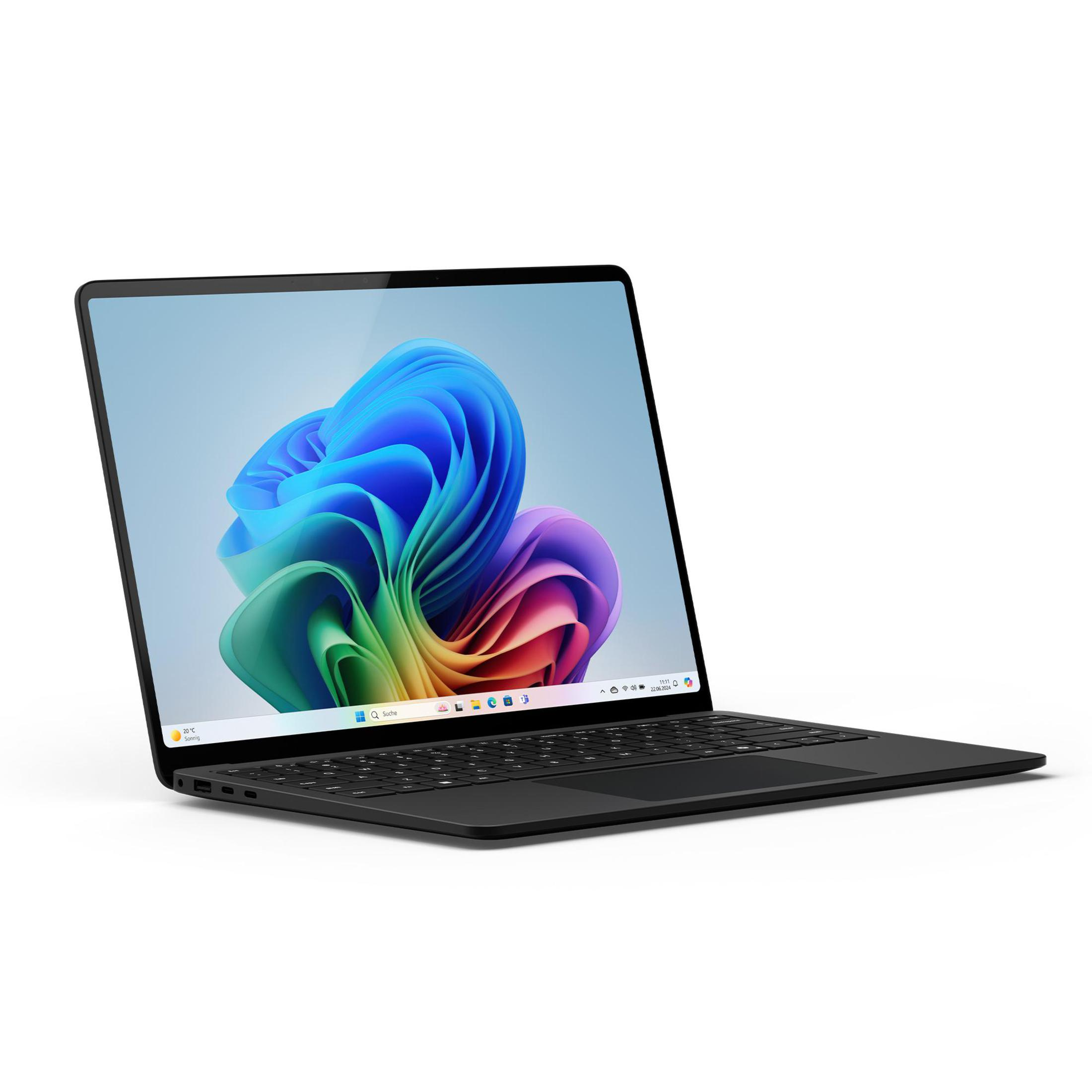 Schwarzer Laptop, teilweise geöffnet. Bunter Desktop-Hintergrund, hellfarbige Oberfläche. Sauberes, modernes Design.