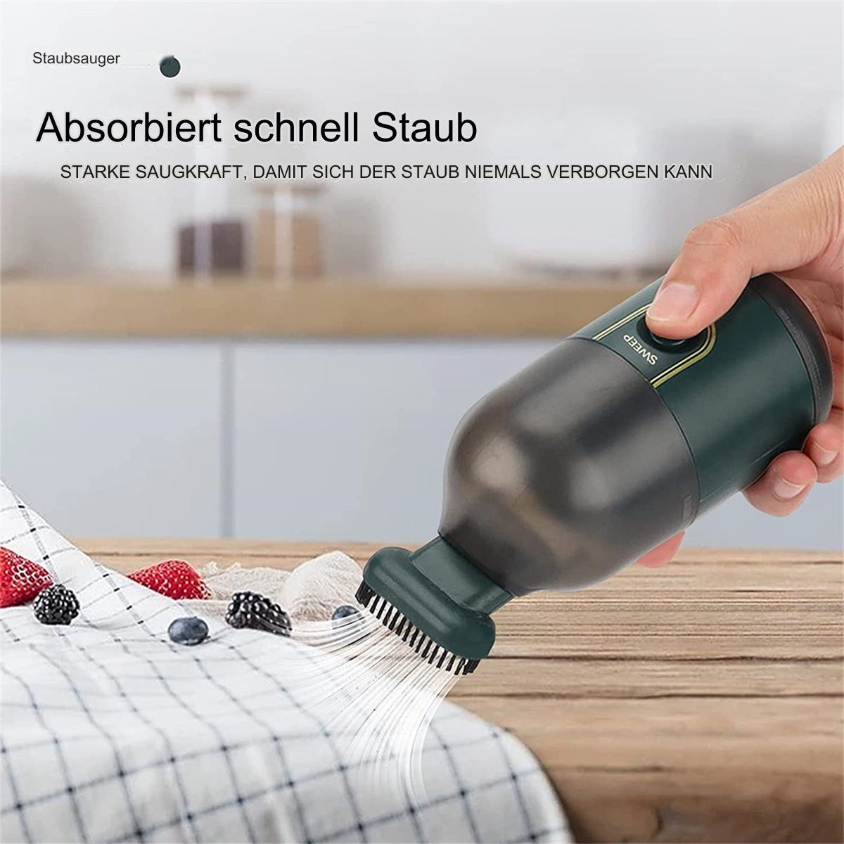 Ein Handstaubsauger. Der Staubsauger ist dunkelgrün und hat einen Bürstenaufsatz.