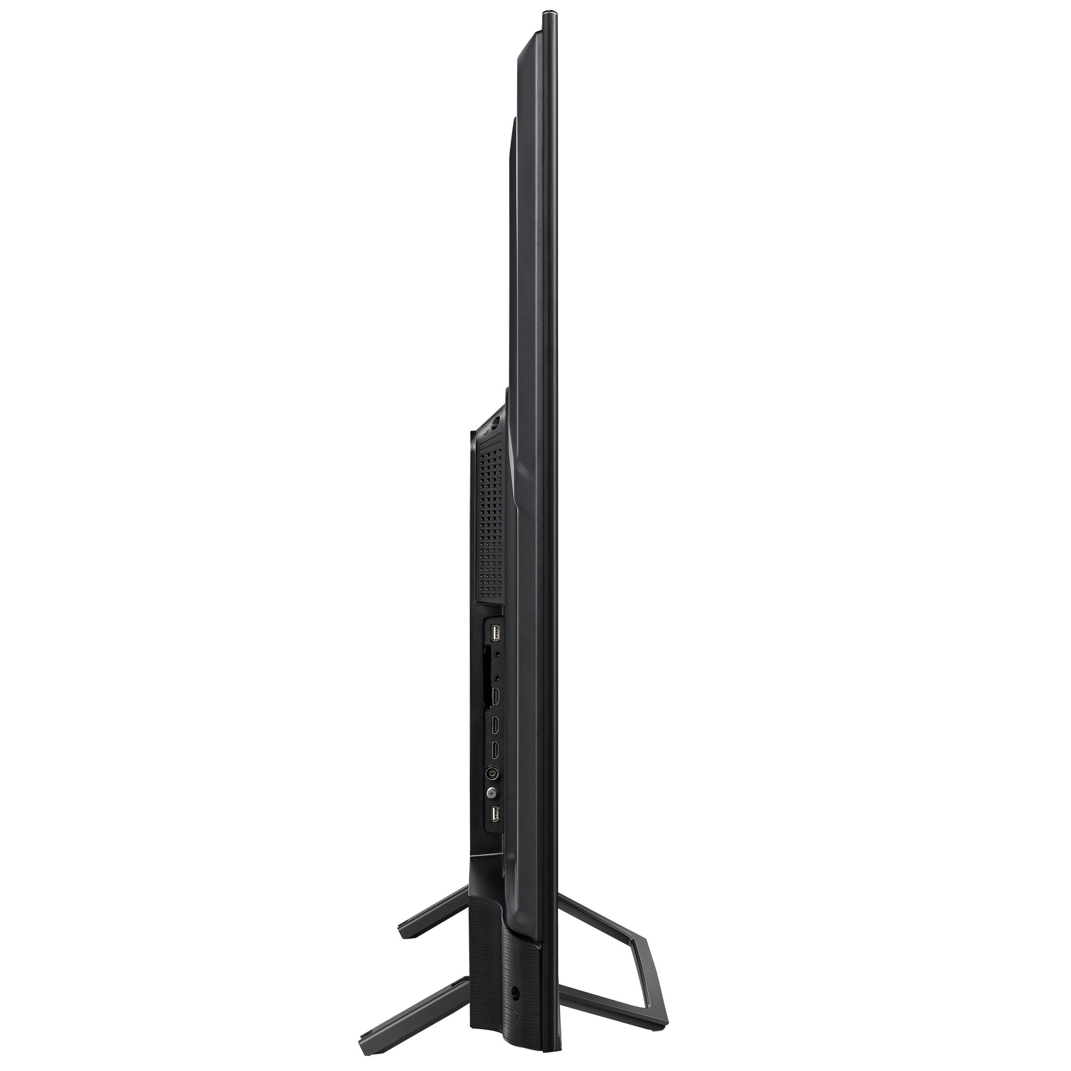 Smukły, czarny telewizor stoi na nóżkach. Z boku widać porty.