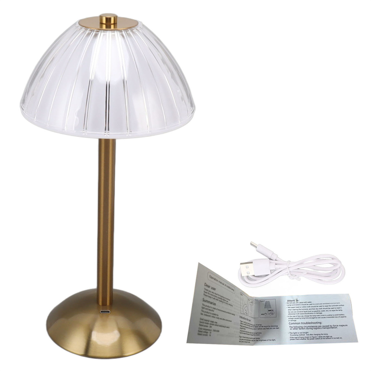 Goldene Tischlampe mit transparentem Schirm und USB-Ladekabel.