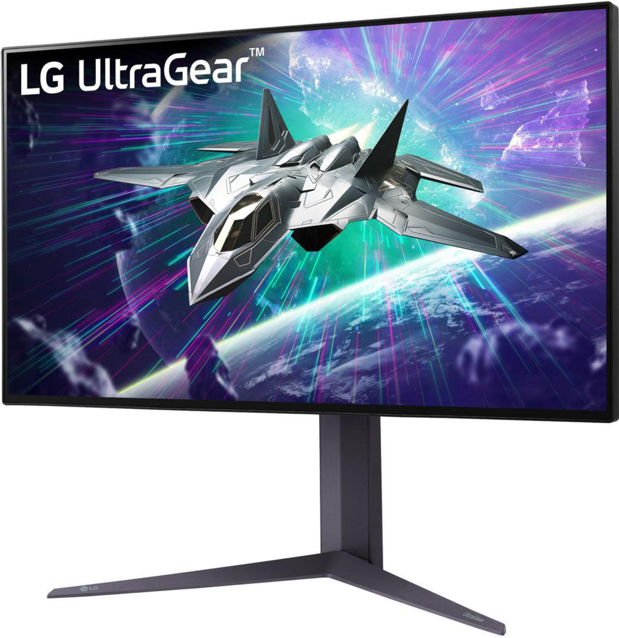 LG UltraGear-Monitor mit Kampfflugzeuggrafik auf dem Bildschirm, dunklem Ständer und schwarzem Rahmen.
