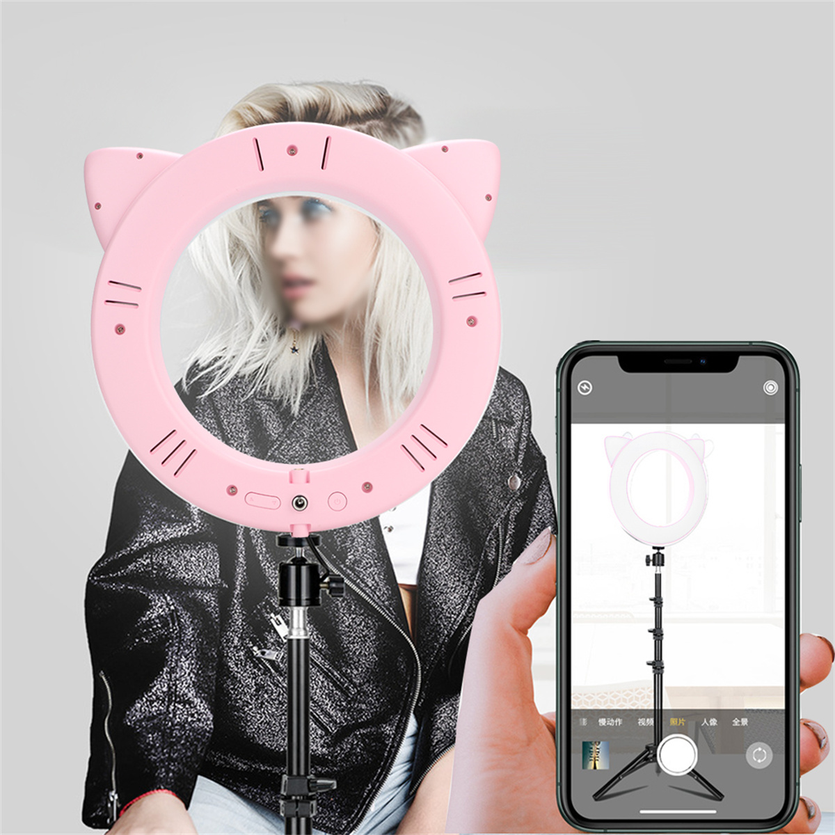 Ein rosa Katzenohren-Ringlicht mit einem Telefon, das das Licht zeigt, und eine Frau im Hintergrund.
