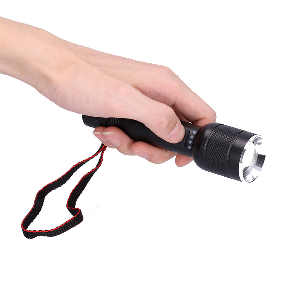 Eine Hand, die eine schwarze Taschenlampe mit rotem Riemen hält.