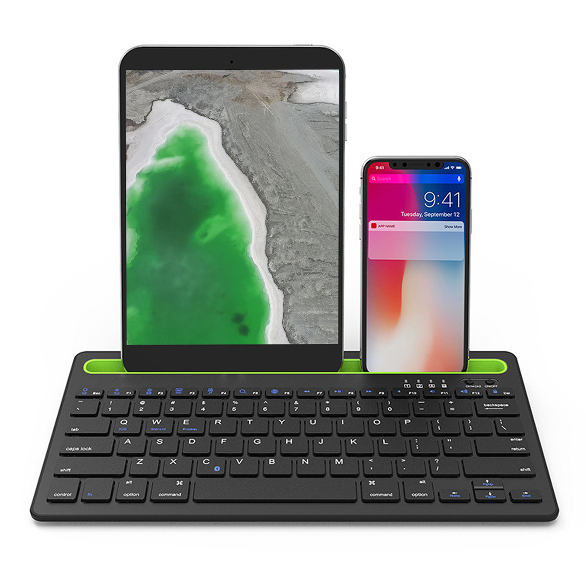 Schwarze Tastatur mit grünem Sockel, ein Tablet und ein Telefon. Weißer Hintergrund.