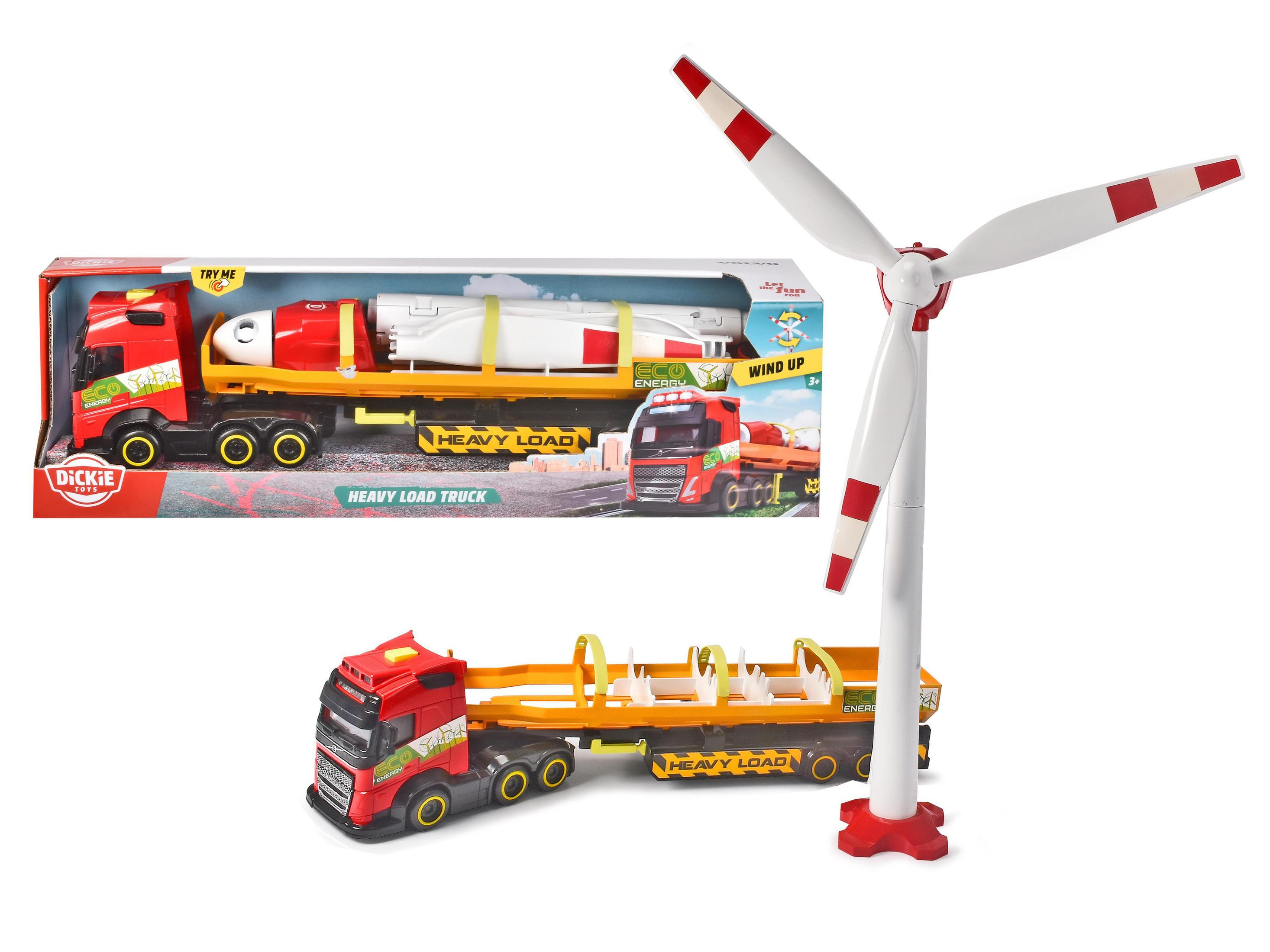 Camion giocattolo con carico pesante. Una turbina eolica giocattolo è accanto.