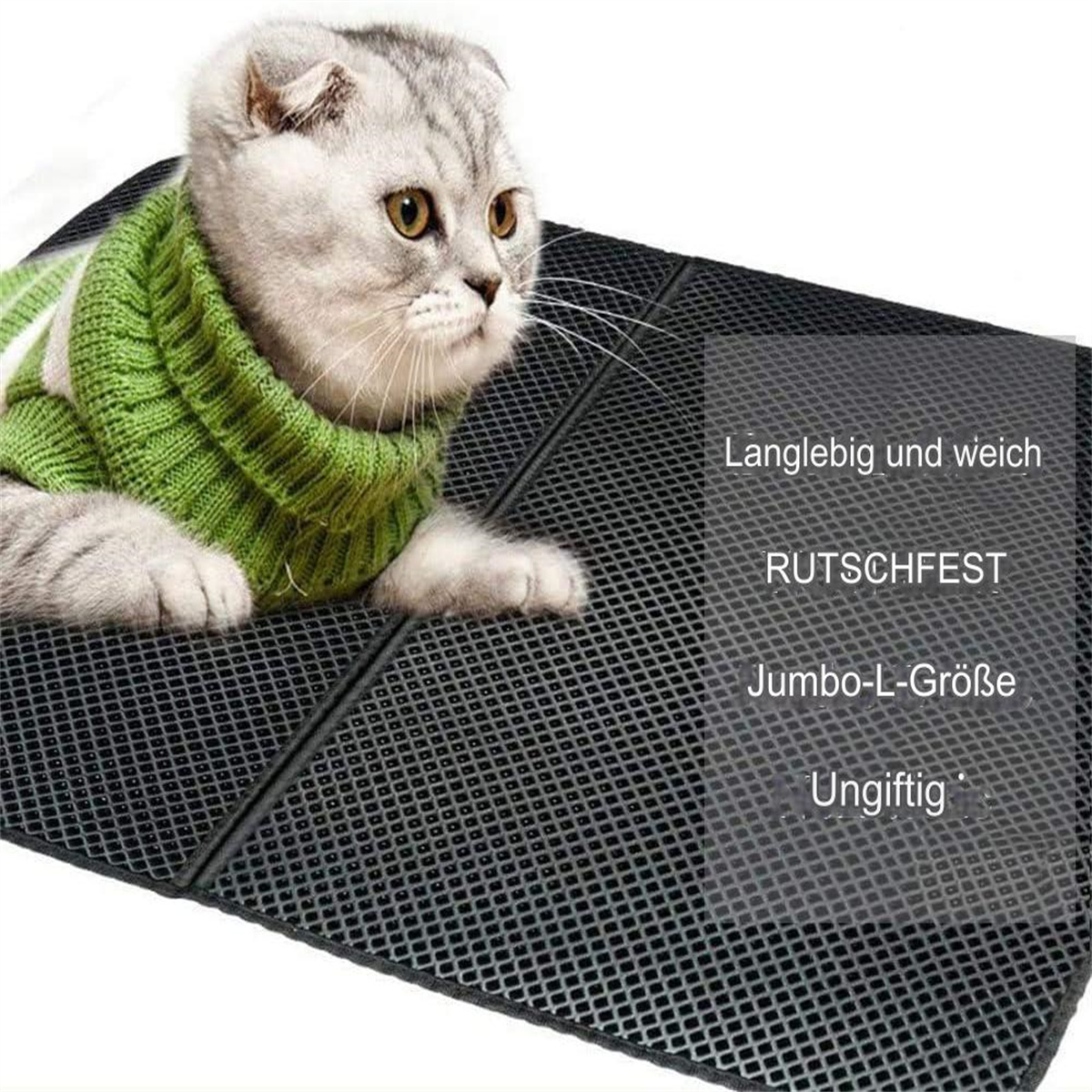 Eine Katze mit grünem Pullover auf einer strukturierten, dunkelgrauen Matte mit Text.