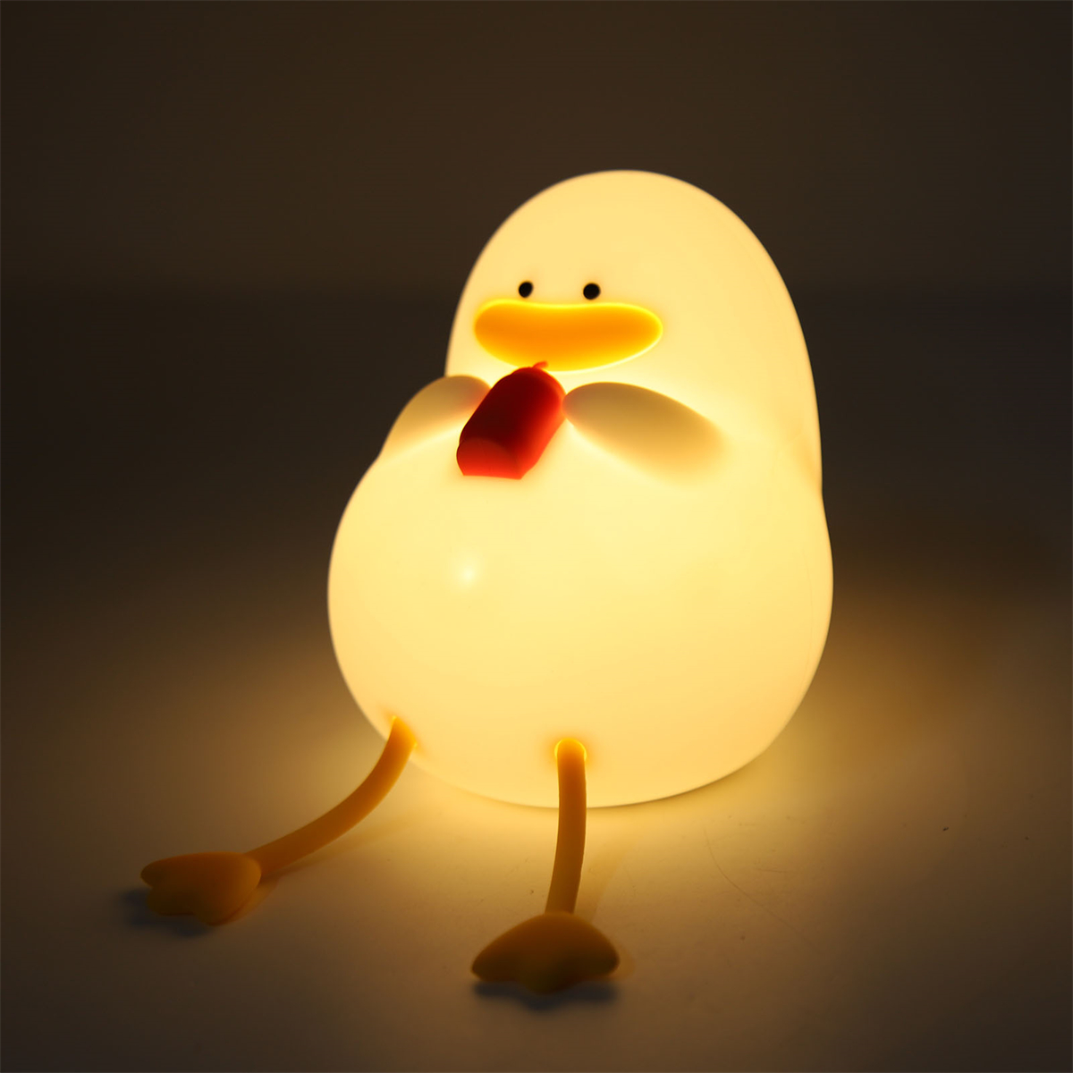 Eine ente-förmige Lampe mit roter Fliege.