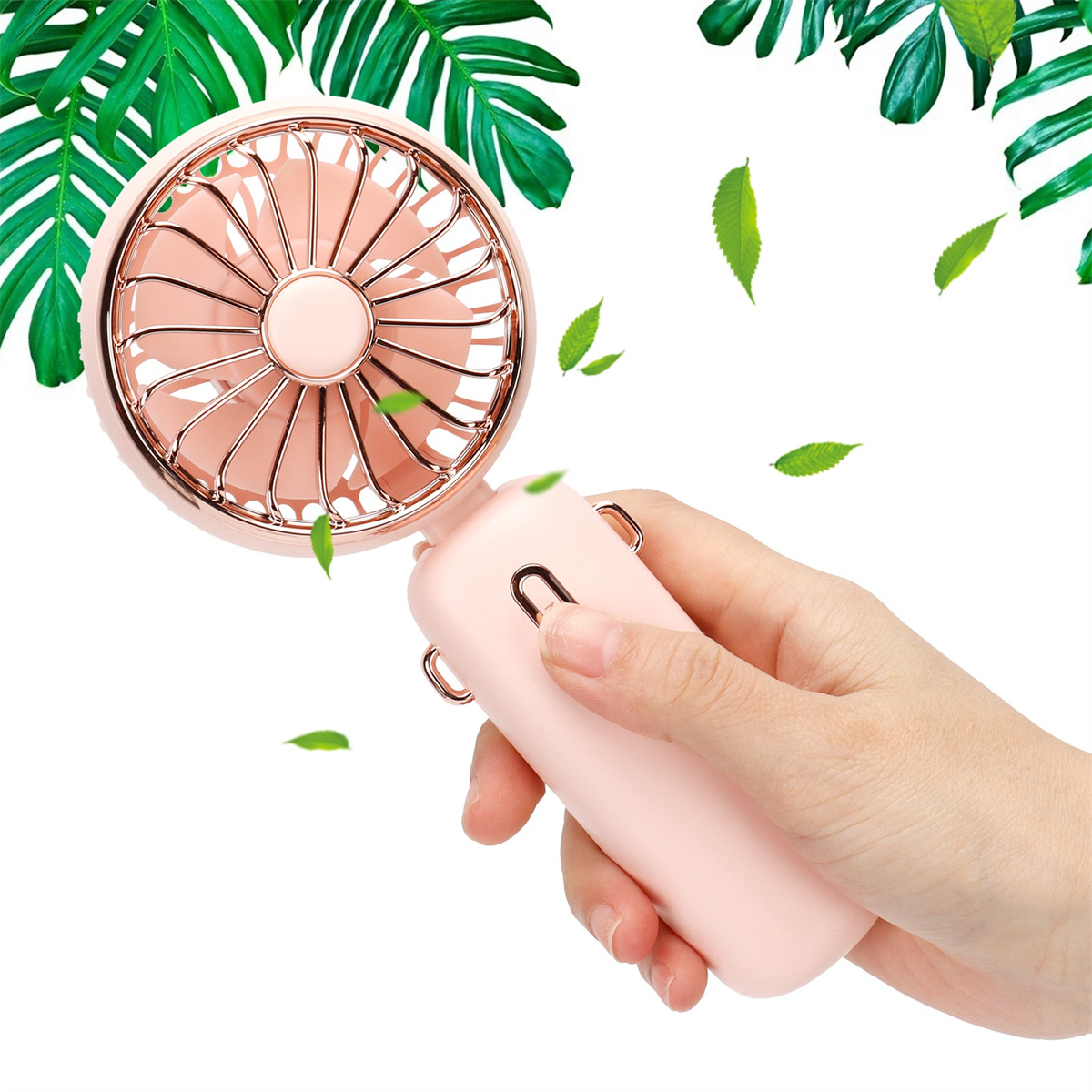 Rosa Handventilator in einer Hand. Grüne Blätter schweben darum.