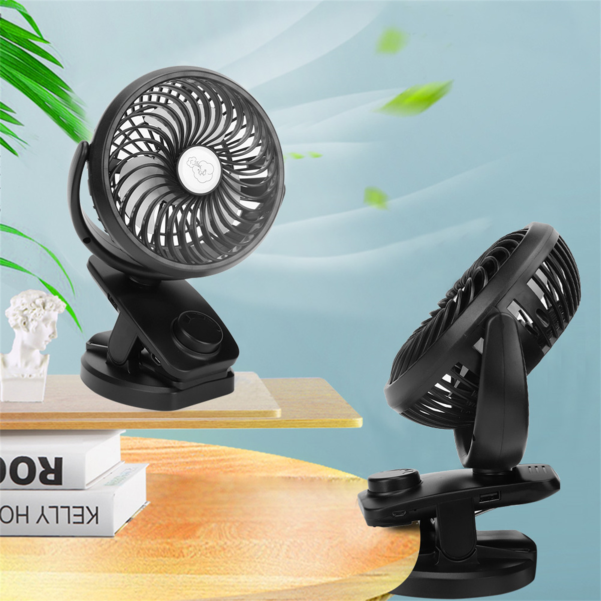 Zwei schwarze Ventilatoren mit Clips, auf einem Tisch platziert. Der linke Ventilator ist zum Betrachter gerichtet.