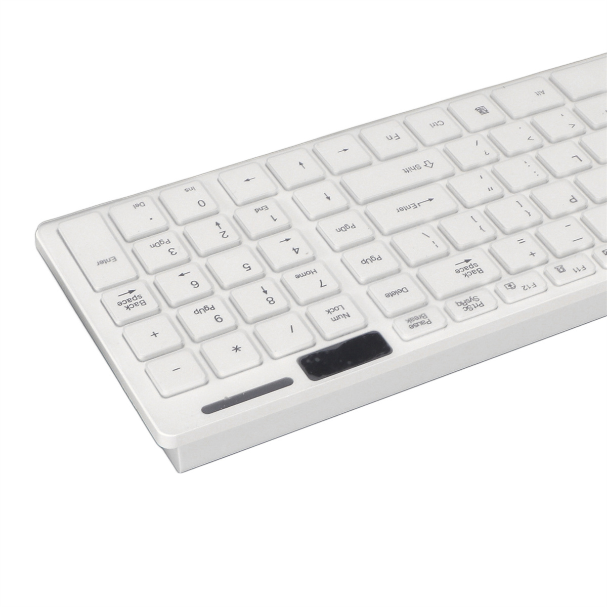 Weiße, kabellose Tastatur. Tasten sind weiß mit schwarzen Buchstaben und Zahlen. Auf weißer Oberfläche.