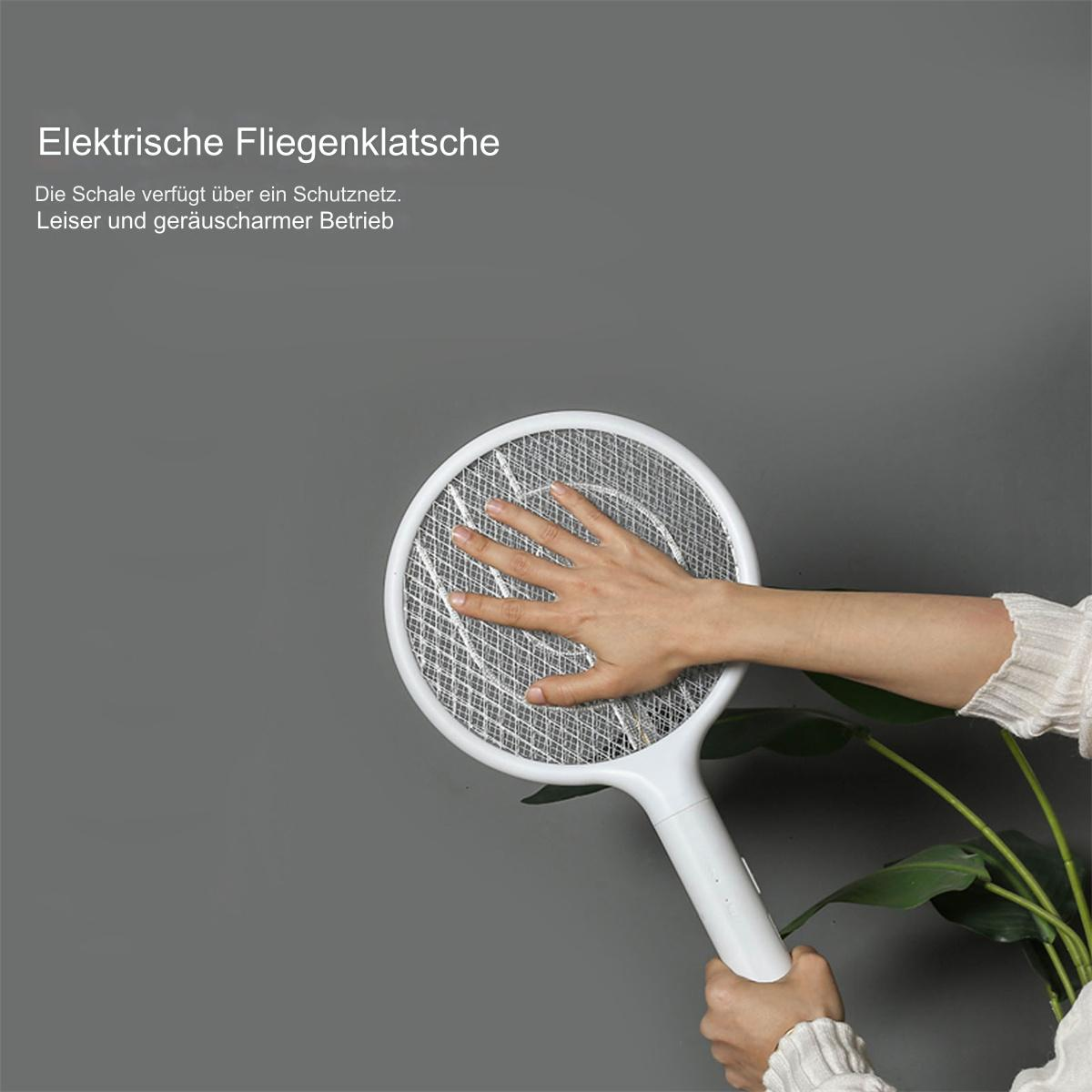 Hand berührt elektrische Fliegenklatsche, weißer Griff und Netz, auf grauem Hintergrund.
