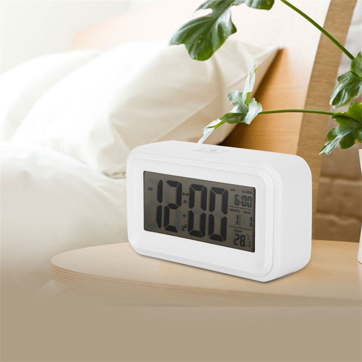 Ein weißer digitaler Wecker auf einem Holztisch. Die angezeigte Uhrzeit ist 12:00, mit Datum und Temperatur.
