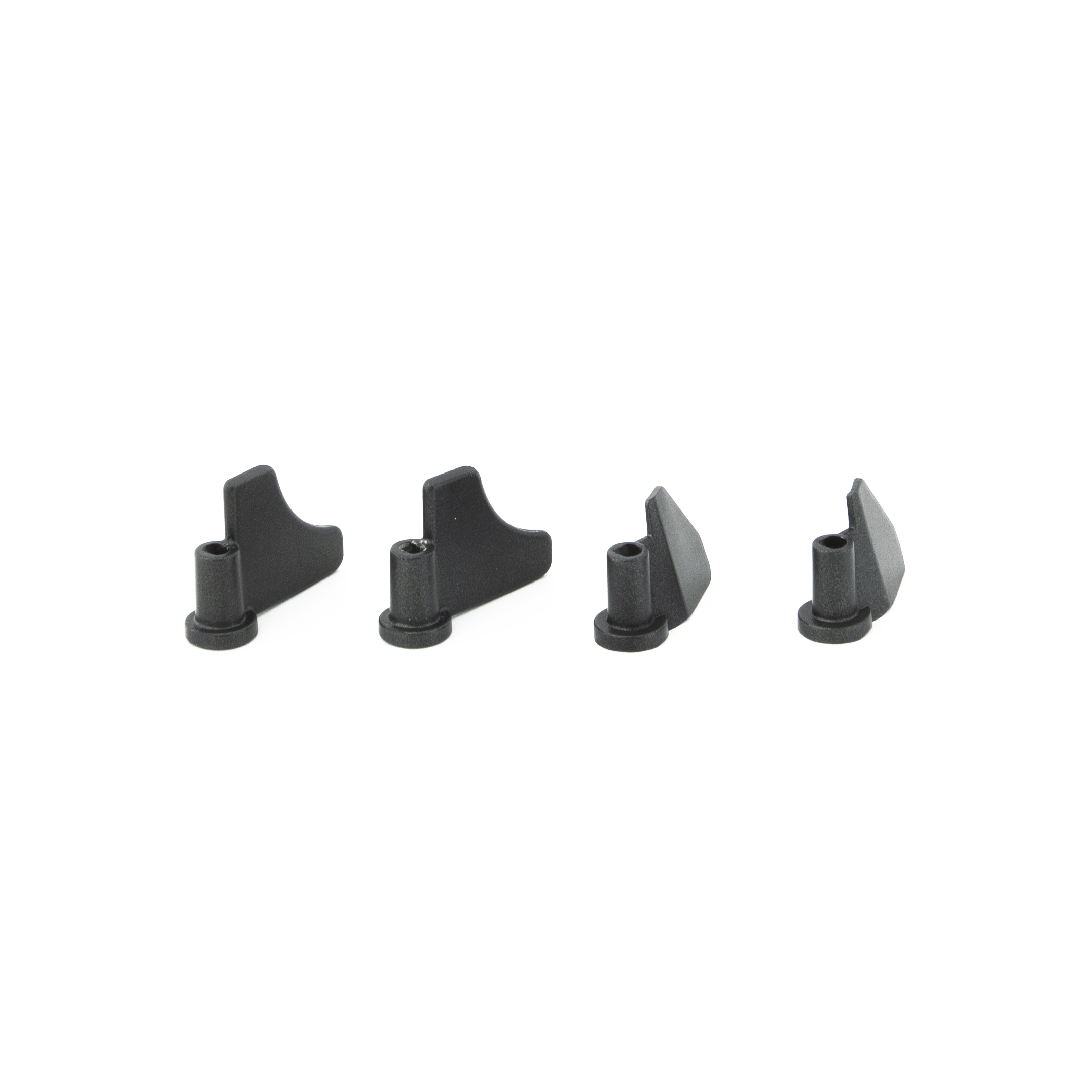 Four black plastic pieces, likely for a kitchen appliance. White background.