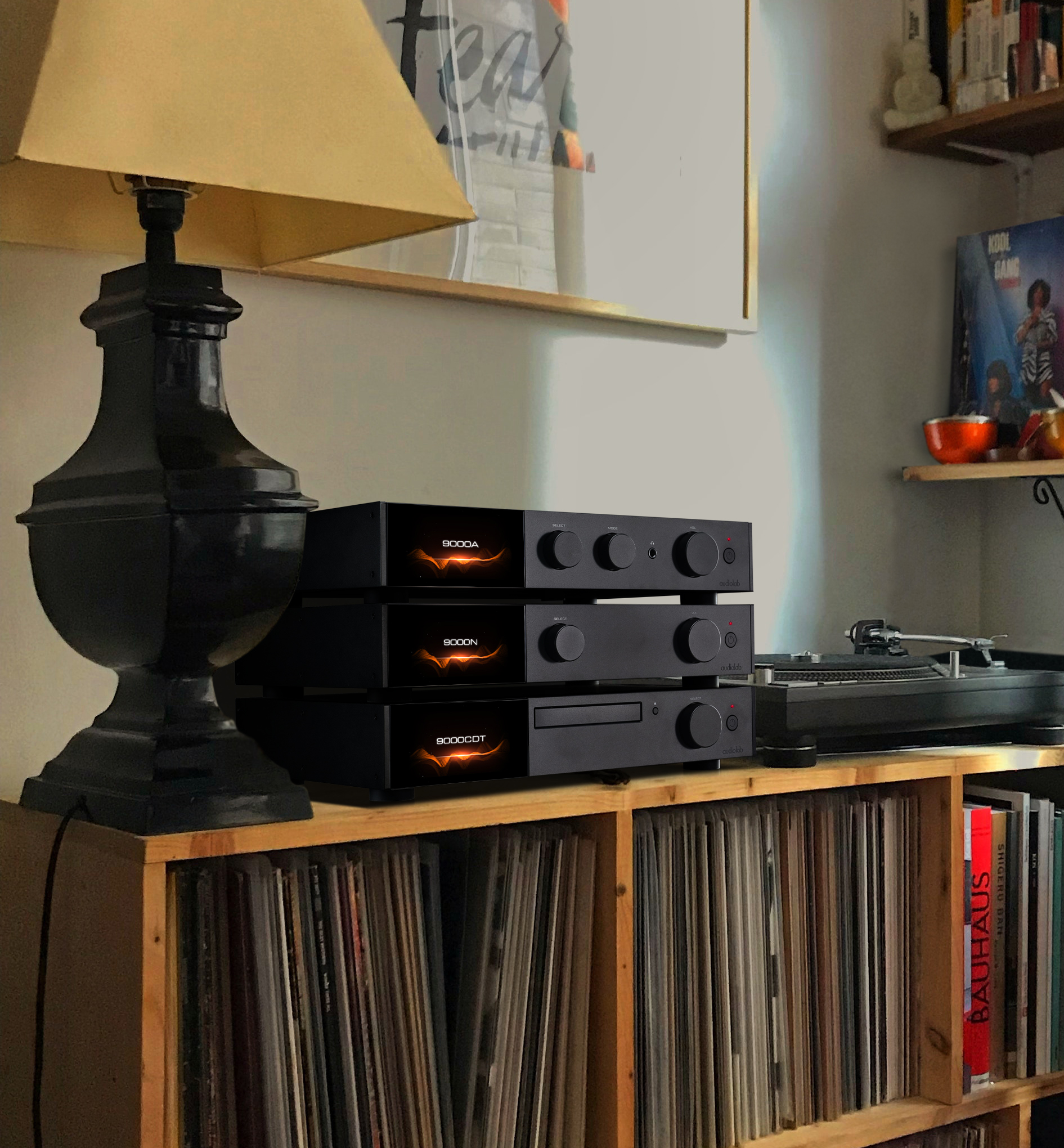 A collection of black audio components stacked on a wooden shelf.