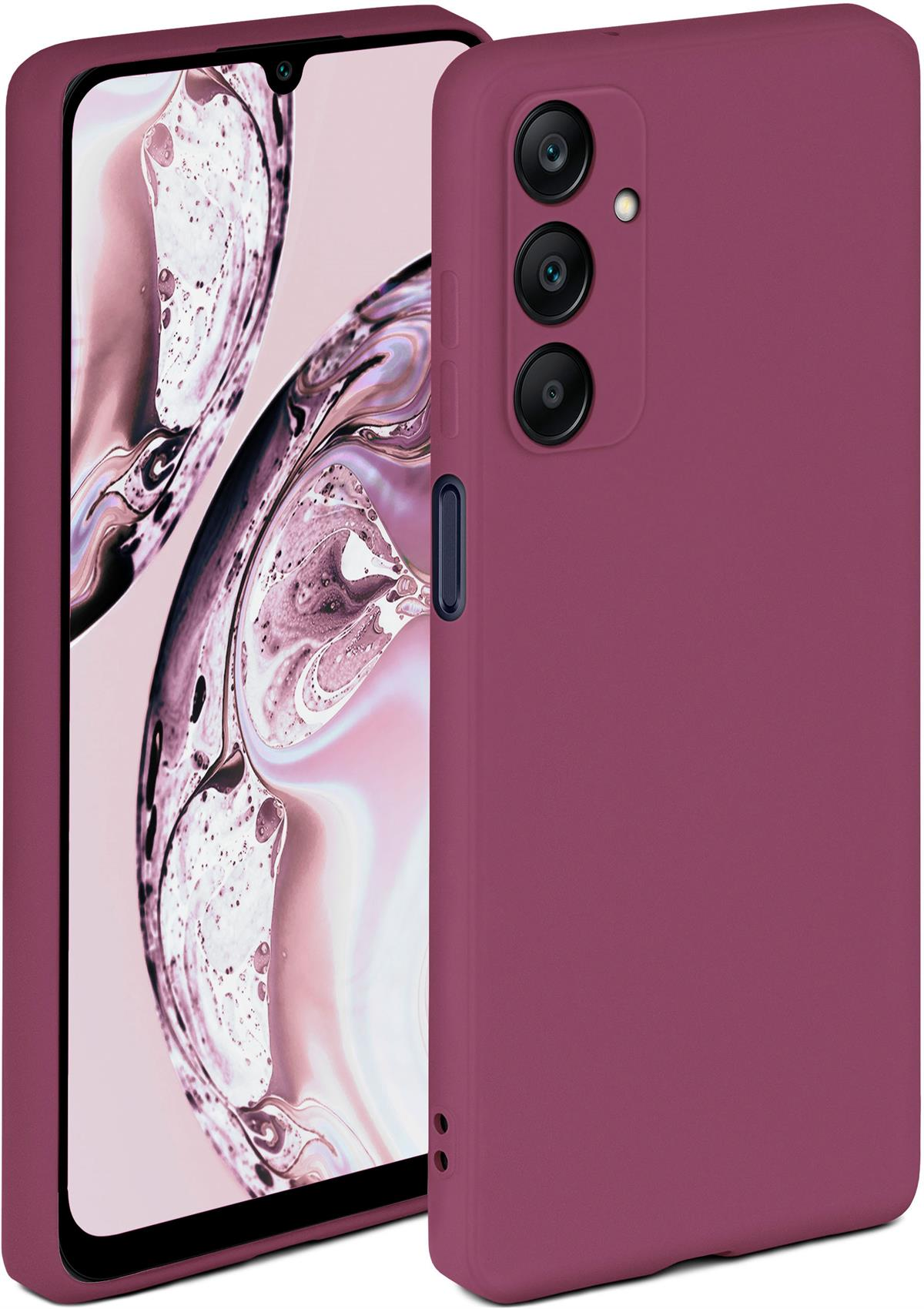 Eine weinrote Handyhülle mit einem Handy darin. Der Hintergrund ist ein abstraktes Design.