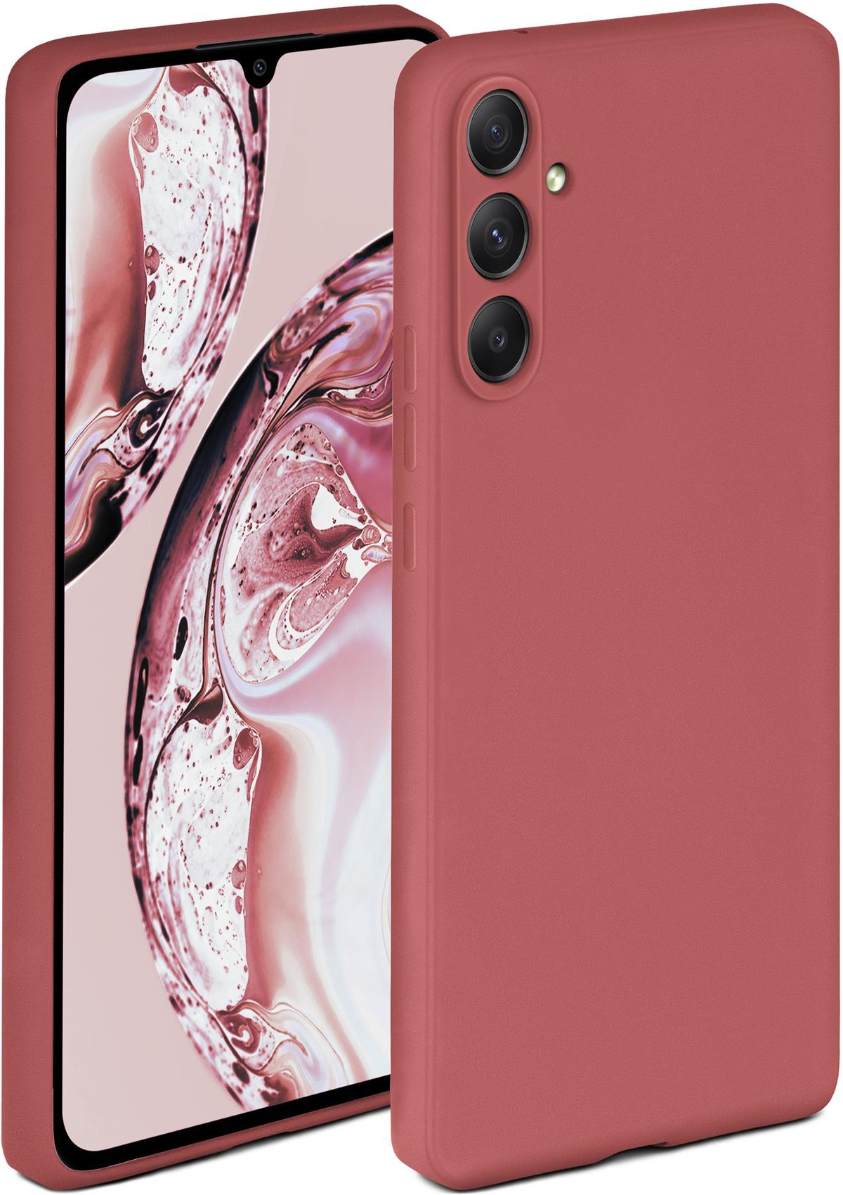 Eine rote Handyhülle mit einem Telefon darin. Der Hintergrund ist verschwommen.