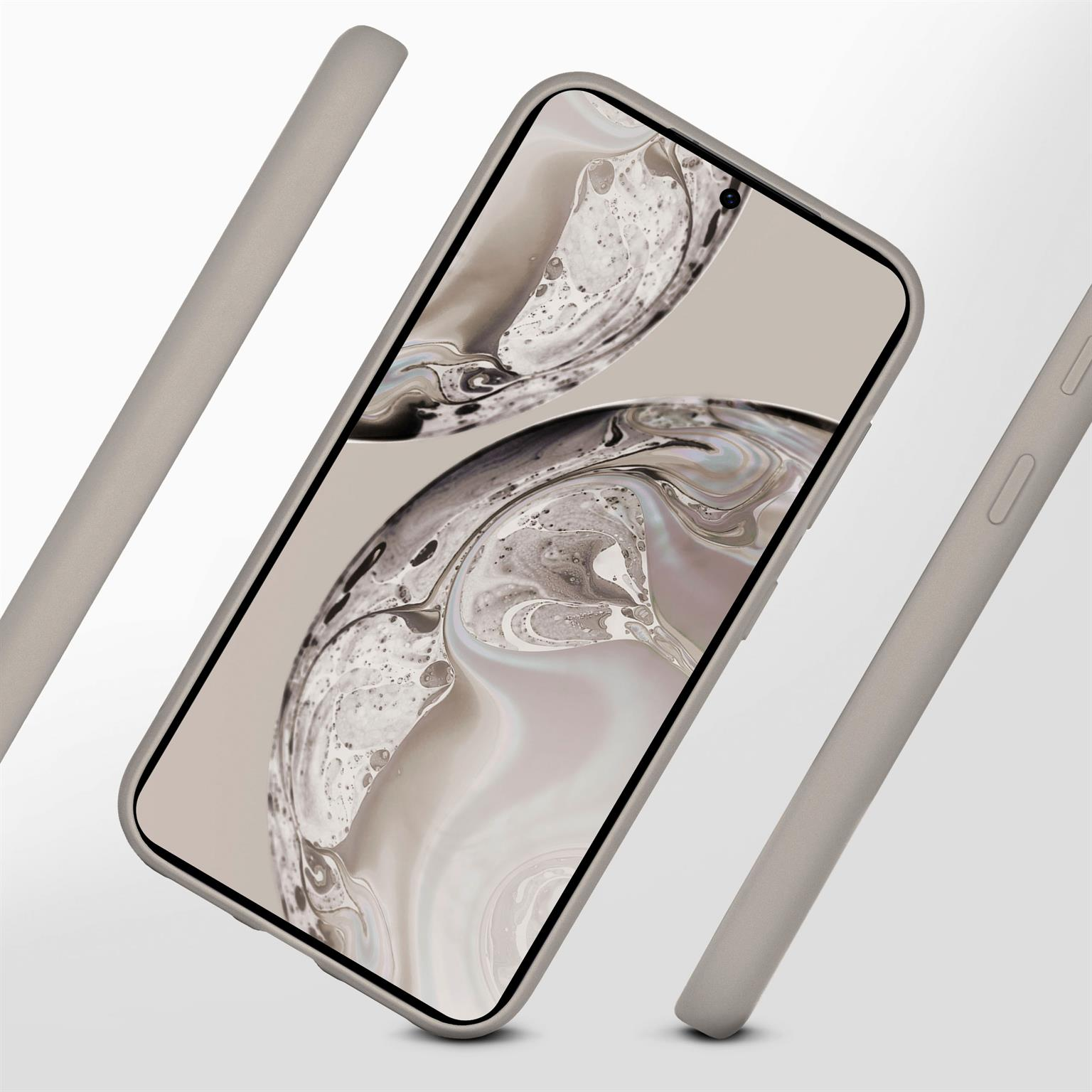 Telefon mit grauem Gehäuse auf einer Oberfläche. Zwei graue und eine schwarze Hülle an der Seite.