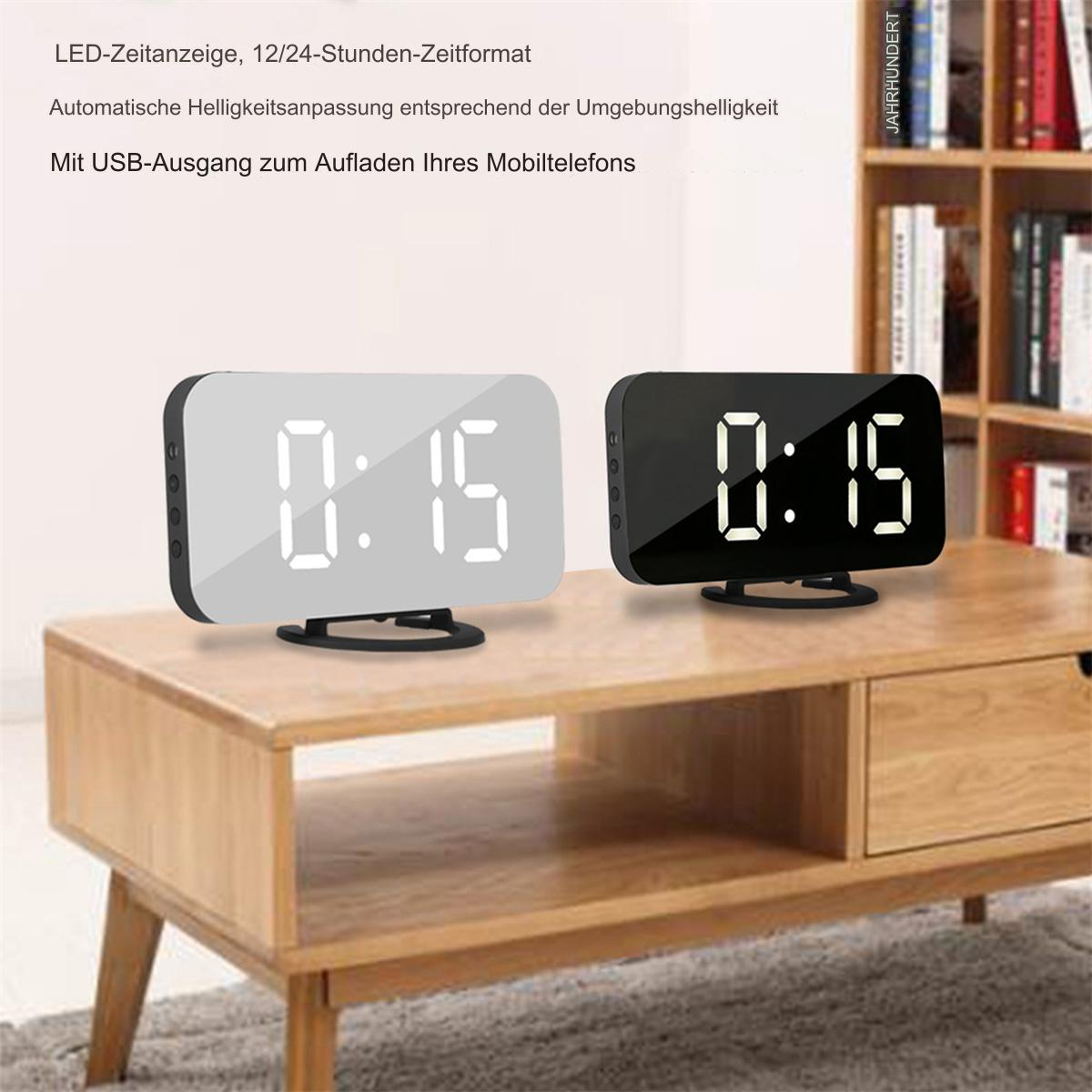 Zwei Digitaluhren zeigen 0:15 an. Eine ist silberfarben, die andere schwarz, beide auf einem Holztisch.