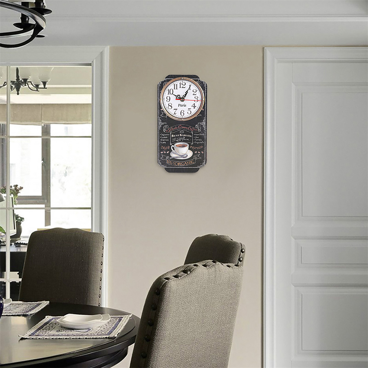 Eine Vintage-Uhr an einer Wand, mit Tisch und Stühlen im Vordergrund.