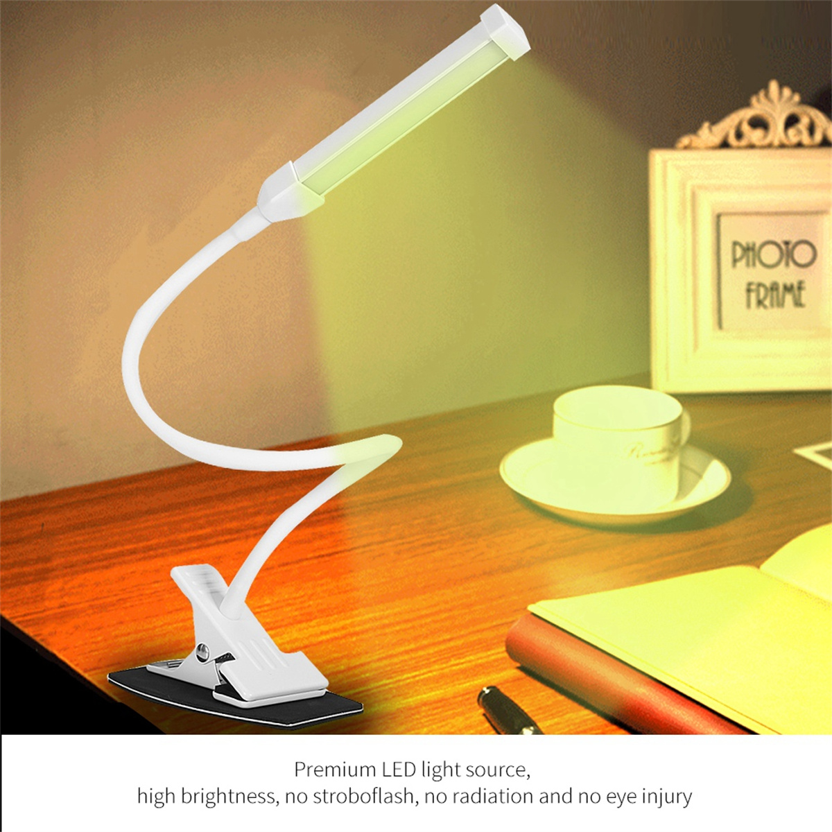 Weiße Lampe mit flexiblem Arm, auf einem Schreibtisch. Bilderrahmen und Tasse im Hintergrund.