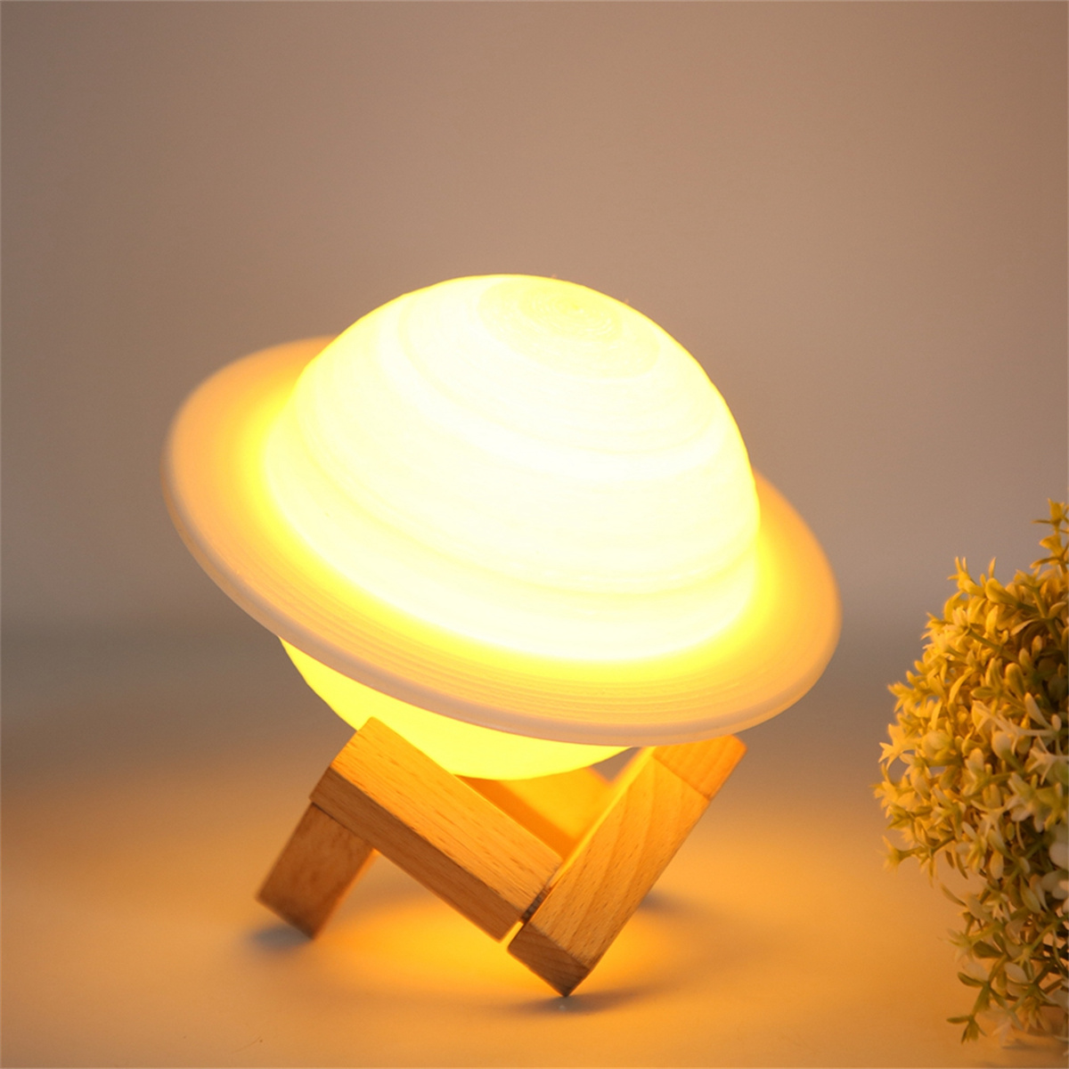 Planetenförmige Lampe mit Holzsockel. Weiches Licht emittiert. Lichtquelle befindet sich oben.