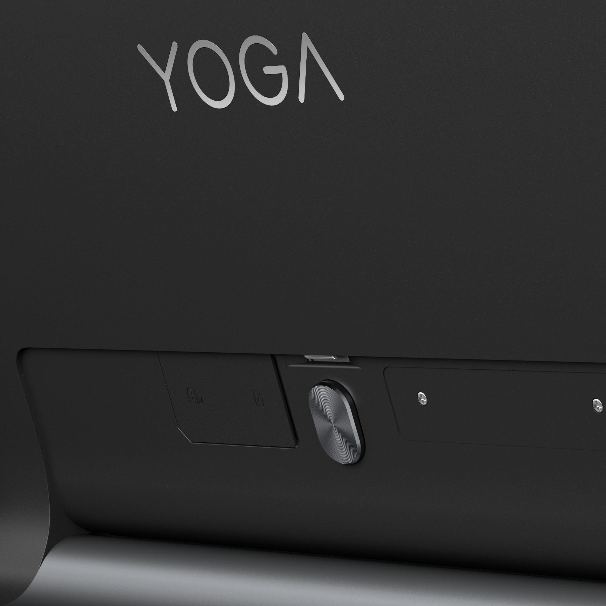 Schwarzes Gerät mit 'YOGA' Text und einem silbernen Knopf. Das Gerät ist grau, der Hintergrund schwarz.