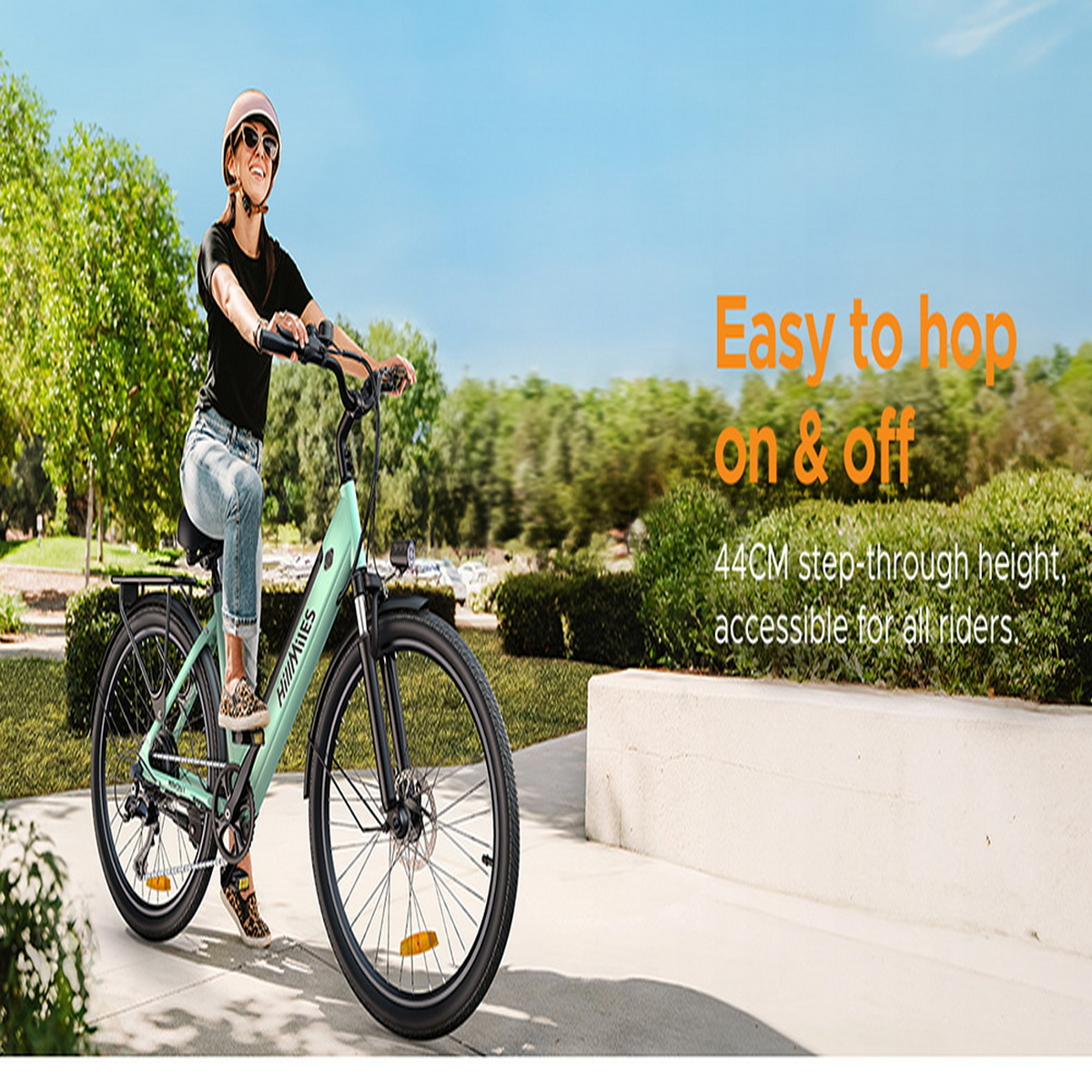 Donna su una bici elettrica verde in una giornata di sole. Testo: Facile da salire e scendere.