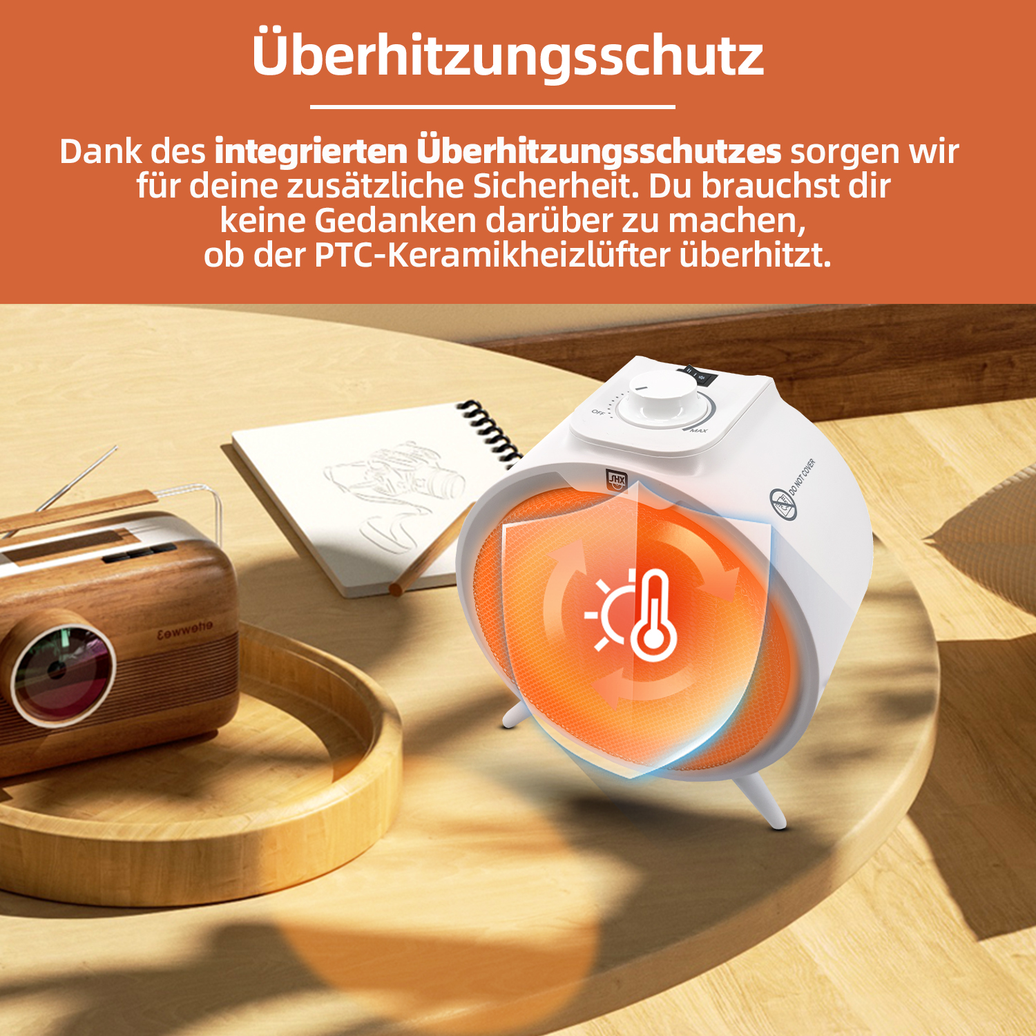 Ein weiß-oranger Heizlüfter mit einem Holzradio links. Der Text oben lautet: Überhitzungsschutz.