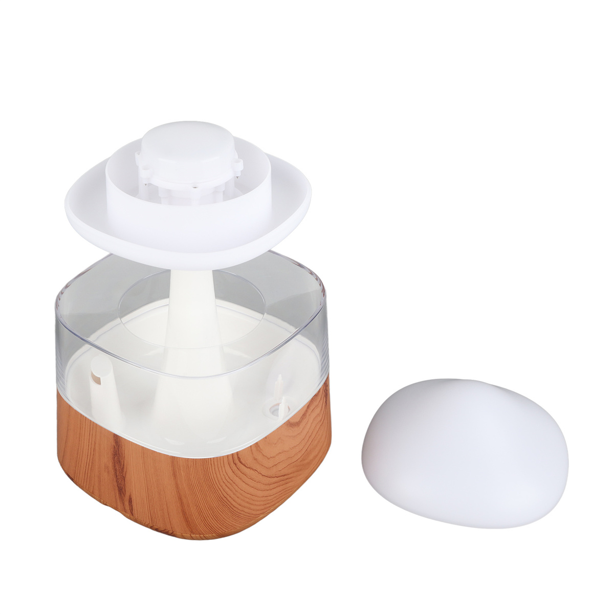 Ein Aromadiffusor mit Holzmaserung, einem durchsichtigen Glaszylinder und einem weißen Deckel.
