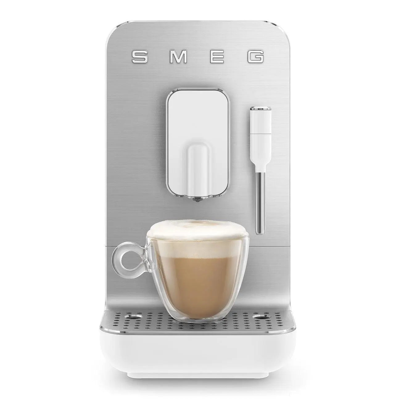 Una cafetera blanca y plateada, preparando café en una taza de vidrio, fondo blanco.