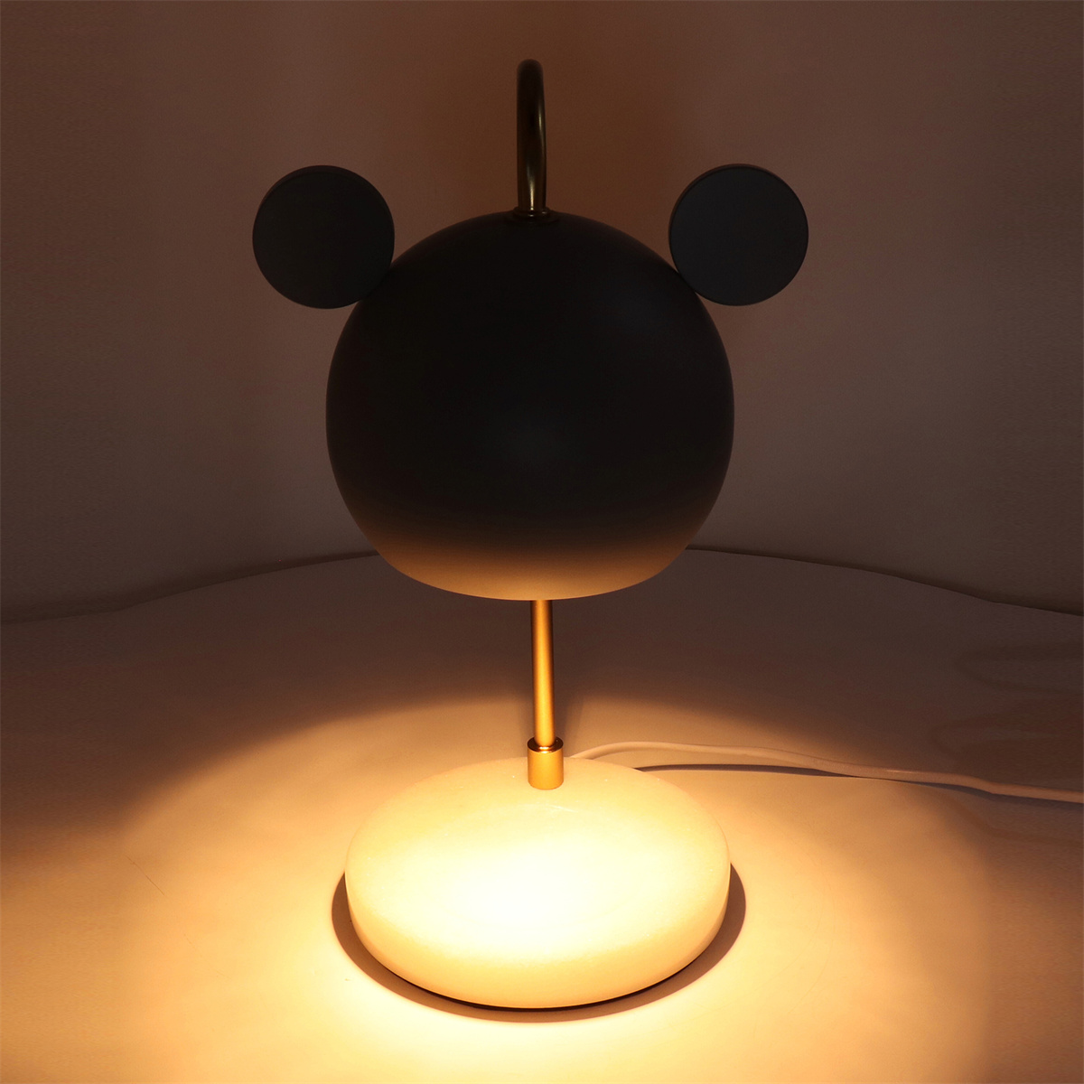 Moderne Schreibtischlampe in Bärenform. Sie hat einen runden Kopf, zwei Ohren und einen Sockel.