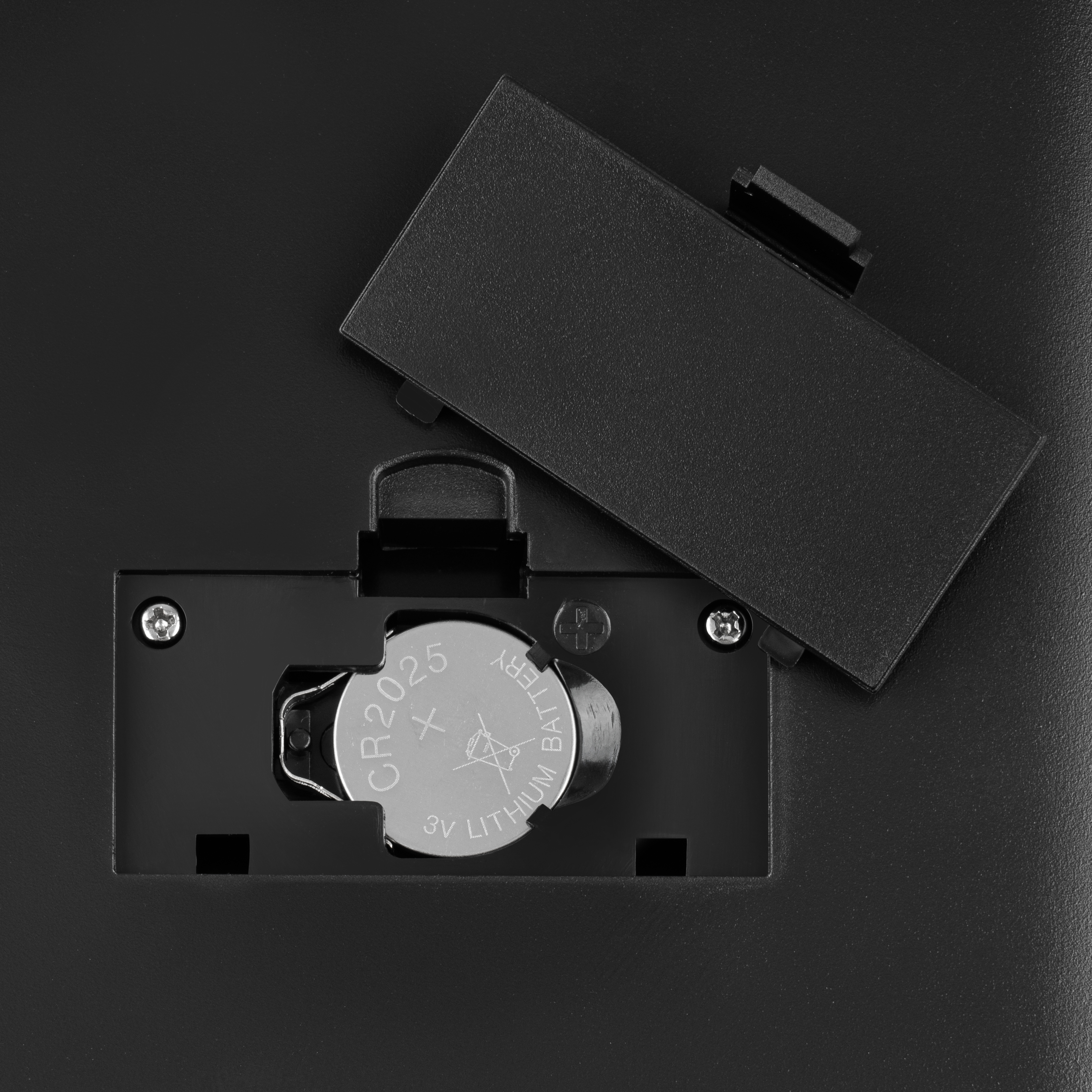 Black battery compartment open. Lithium battery inside.