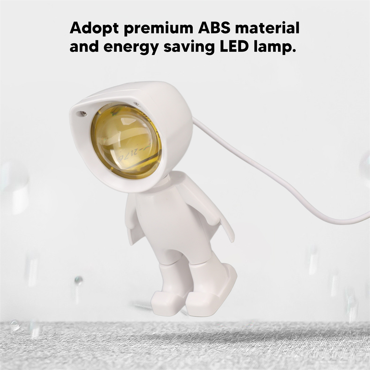 Eine weiße Lampe in Form einer Person, mit gelbem Licht und einem weißen Hintergrund mit Tropfen.
