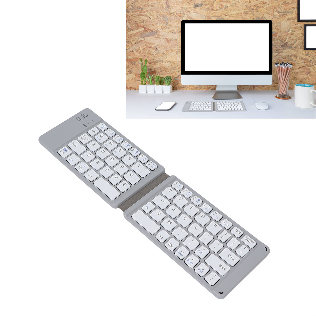 Faltbare graue Tastatur. Ein Computer und andere Büromaterialien befinden sich im Hintergrund.