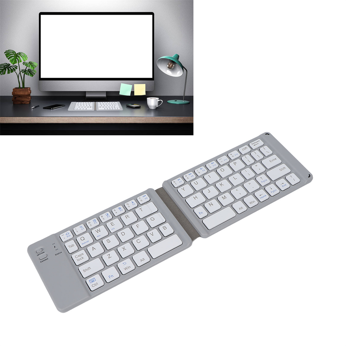 Eine graue, faltbare Tastatur. Ein Monitor mit leerem Bildschirm und ein Schreibtisch mit Gegenständen.